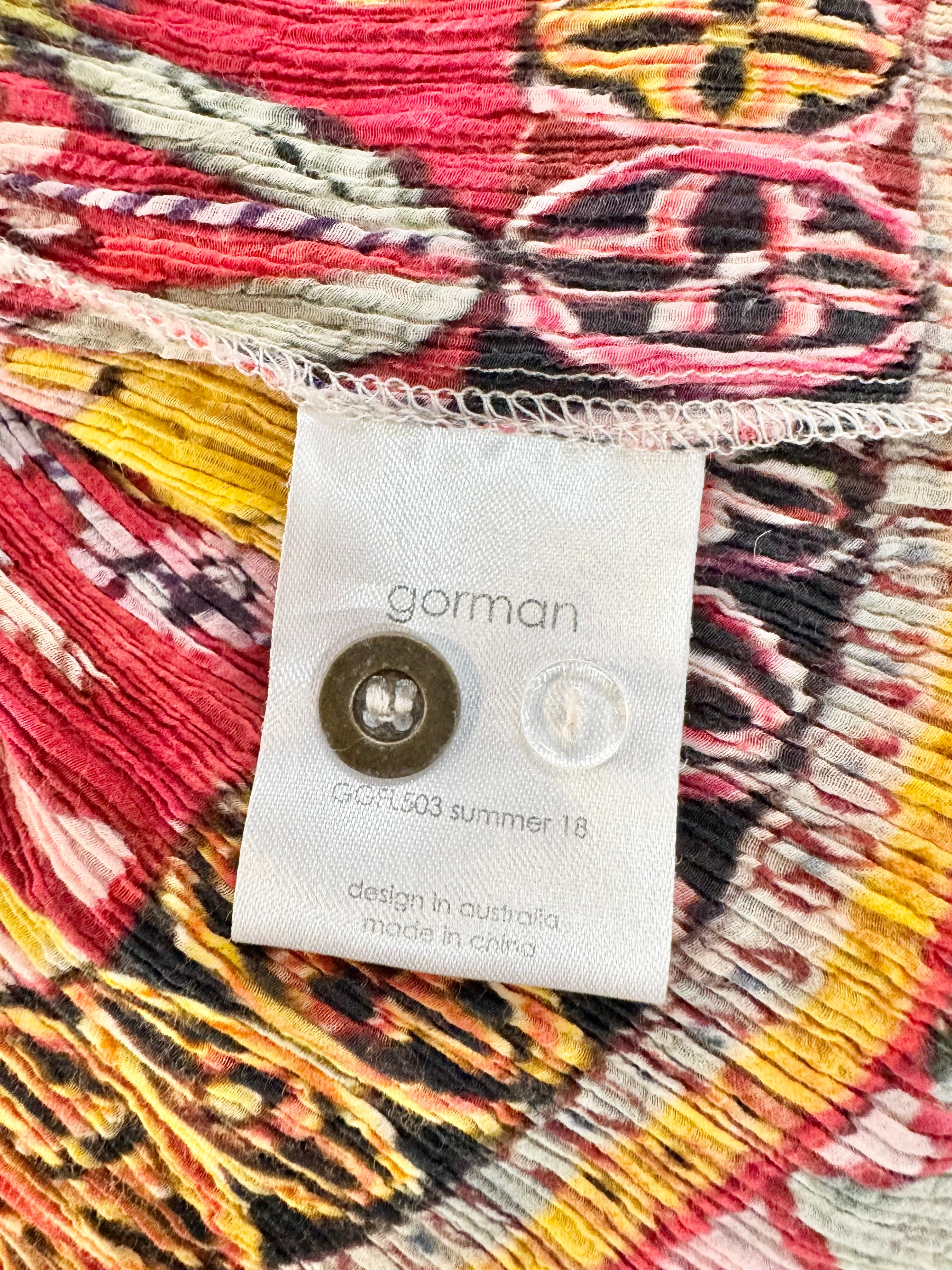 Close-up of a colorful fabric with a 'gorman' label on a vibrant background
