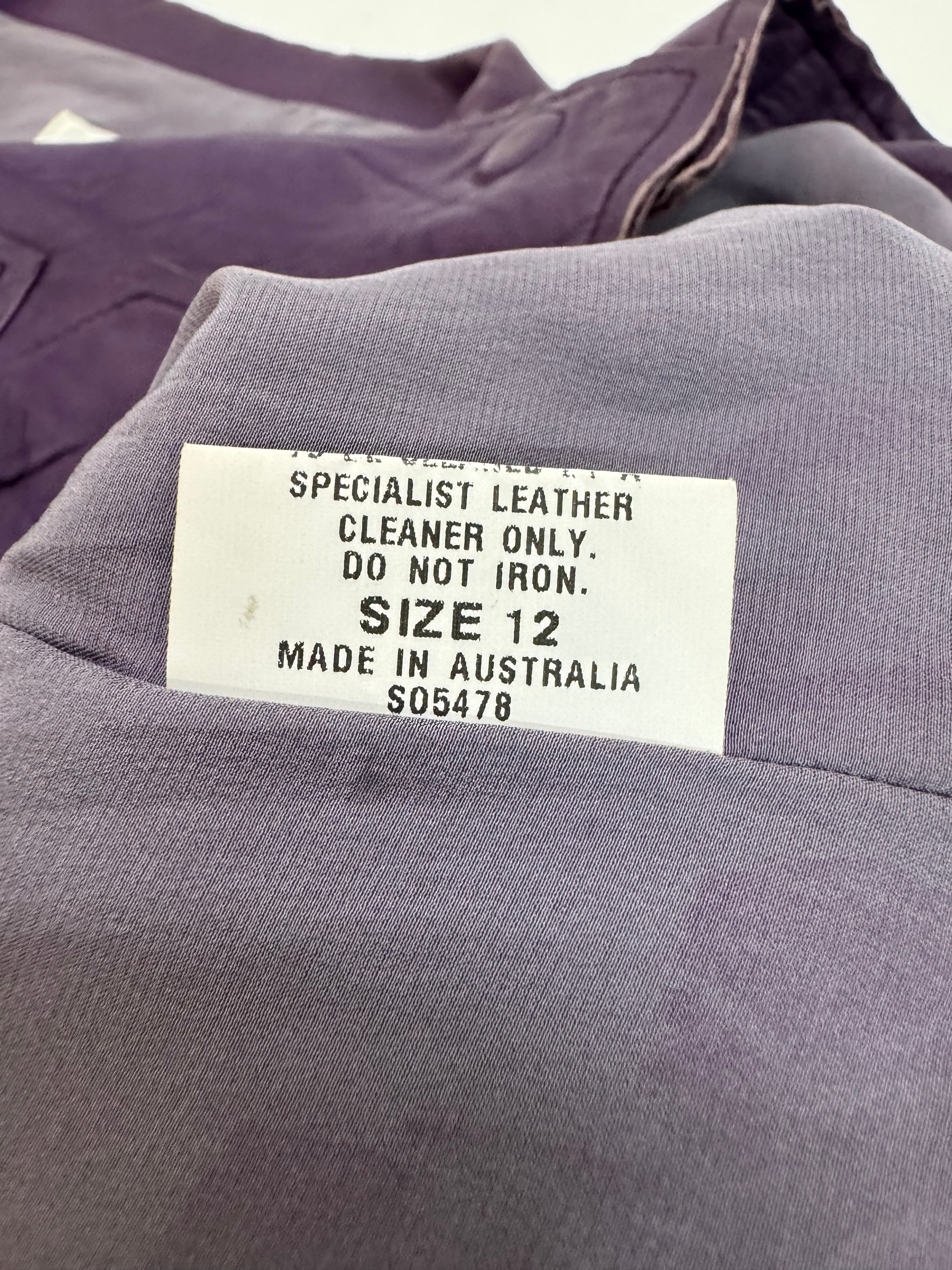 Label on a gray garment with text about care instructions and size.