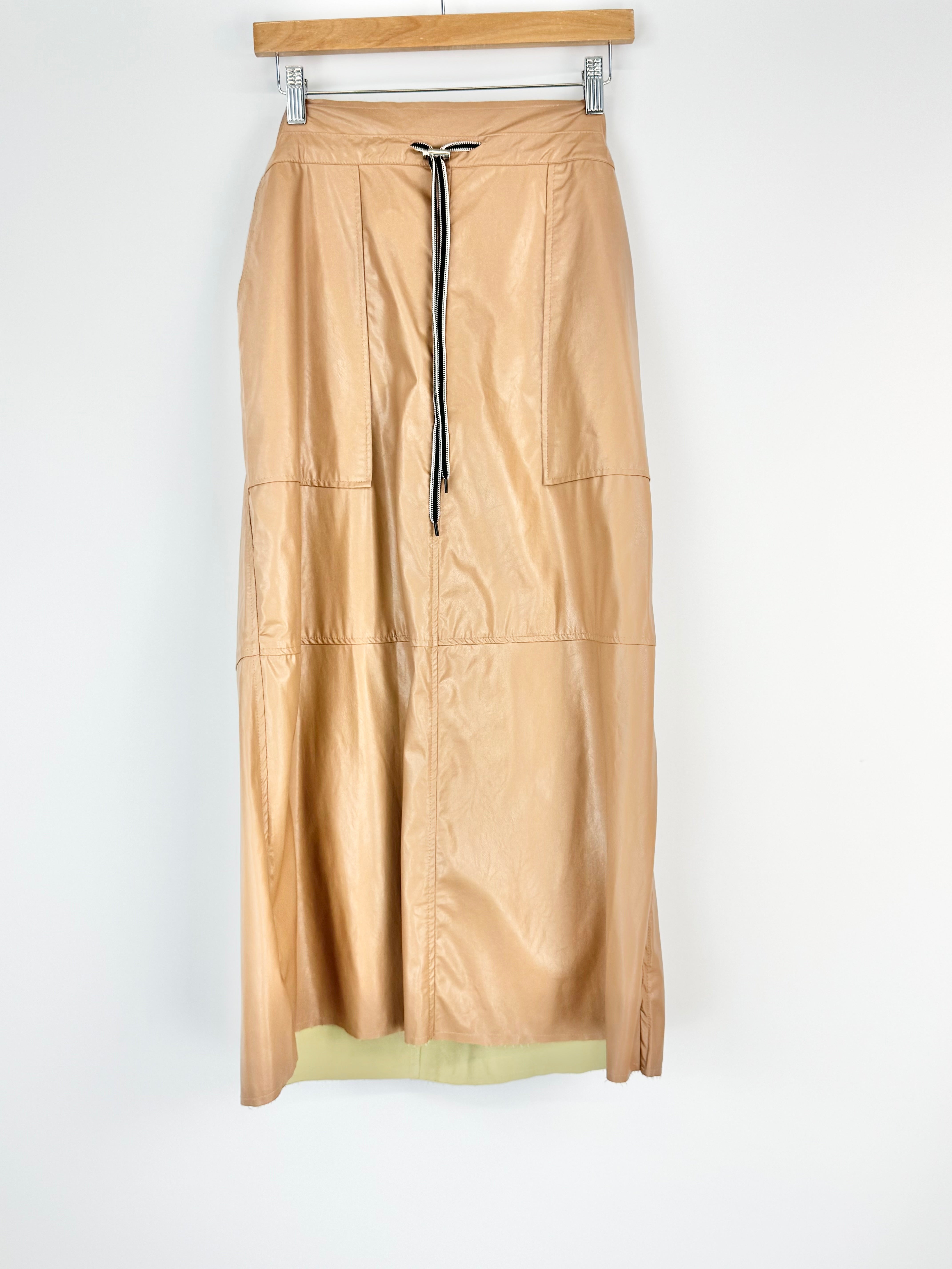 Beige skirt on a hanger against a white background