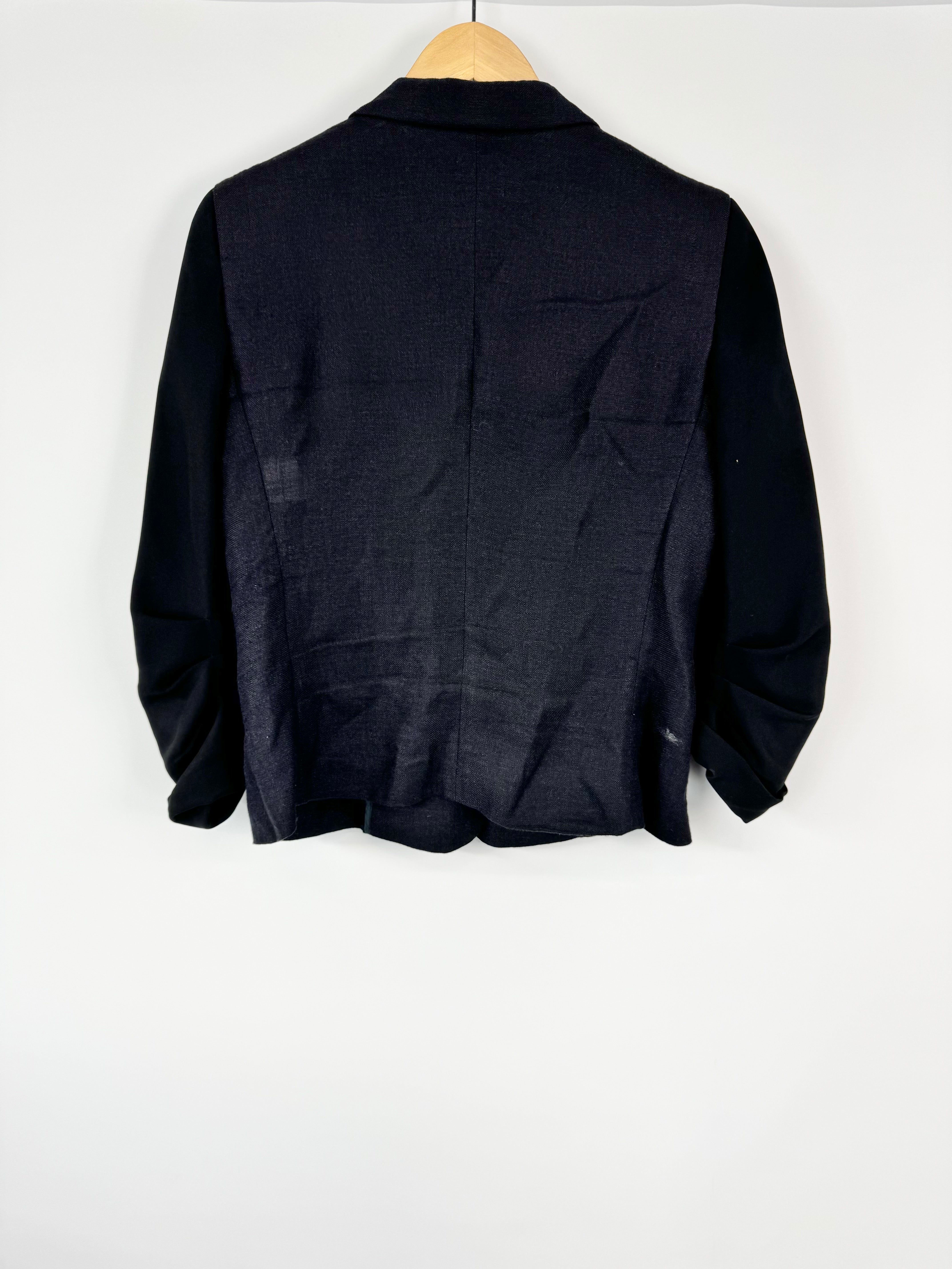 Black jacket on a hanger against a white background