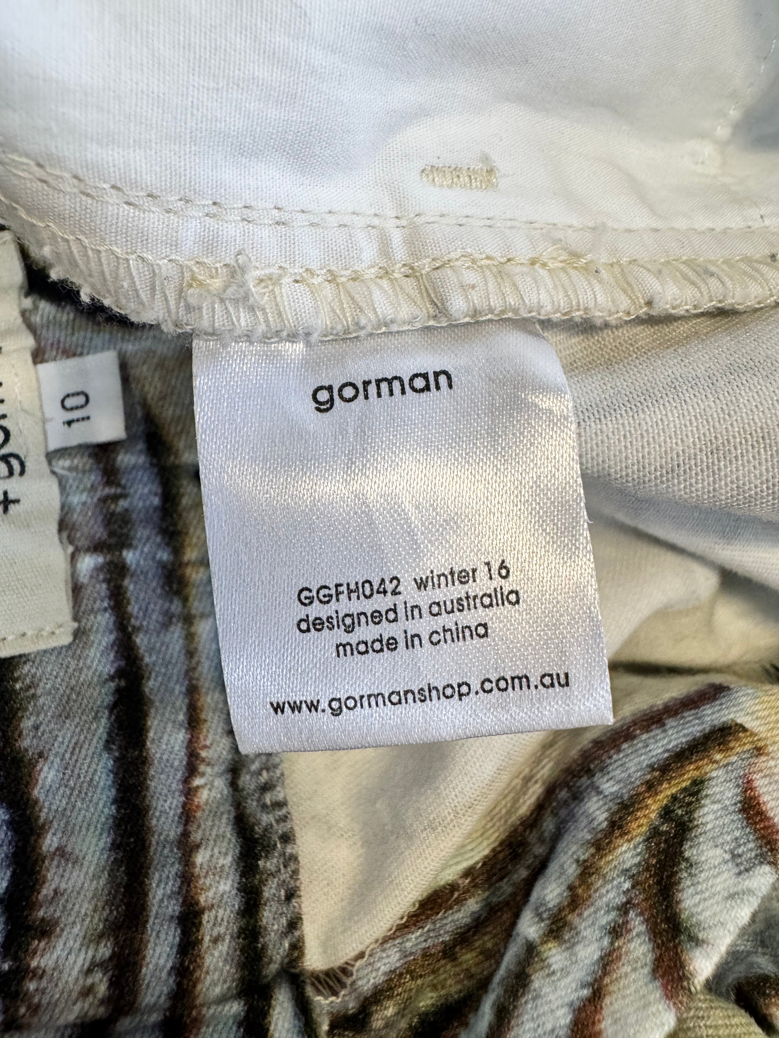 Close-up of a Gorman label on fabric with visible text.