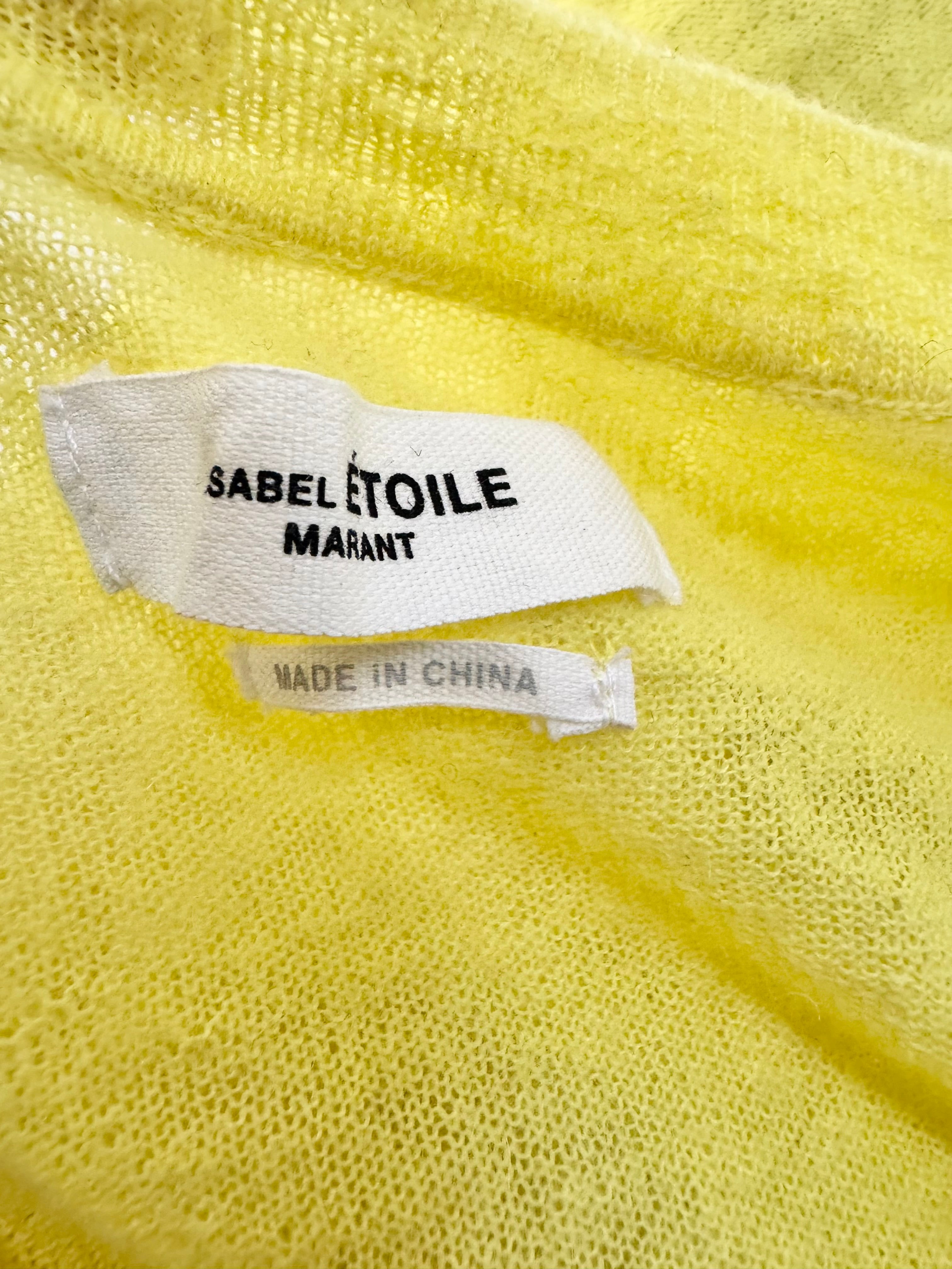 Close-up of a label on a yellow fabric with 'Sabelétoile Marant' branding.