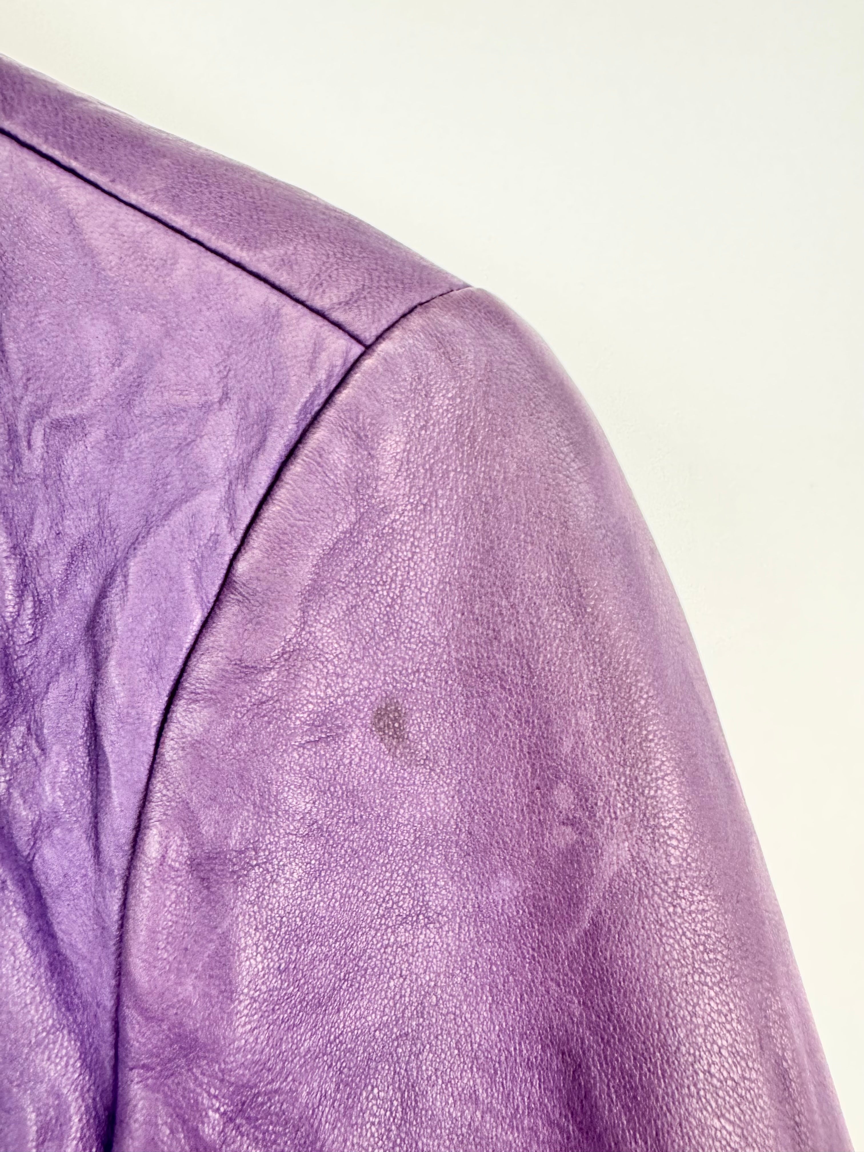 Close-up of a purple leather jacket on a white background