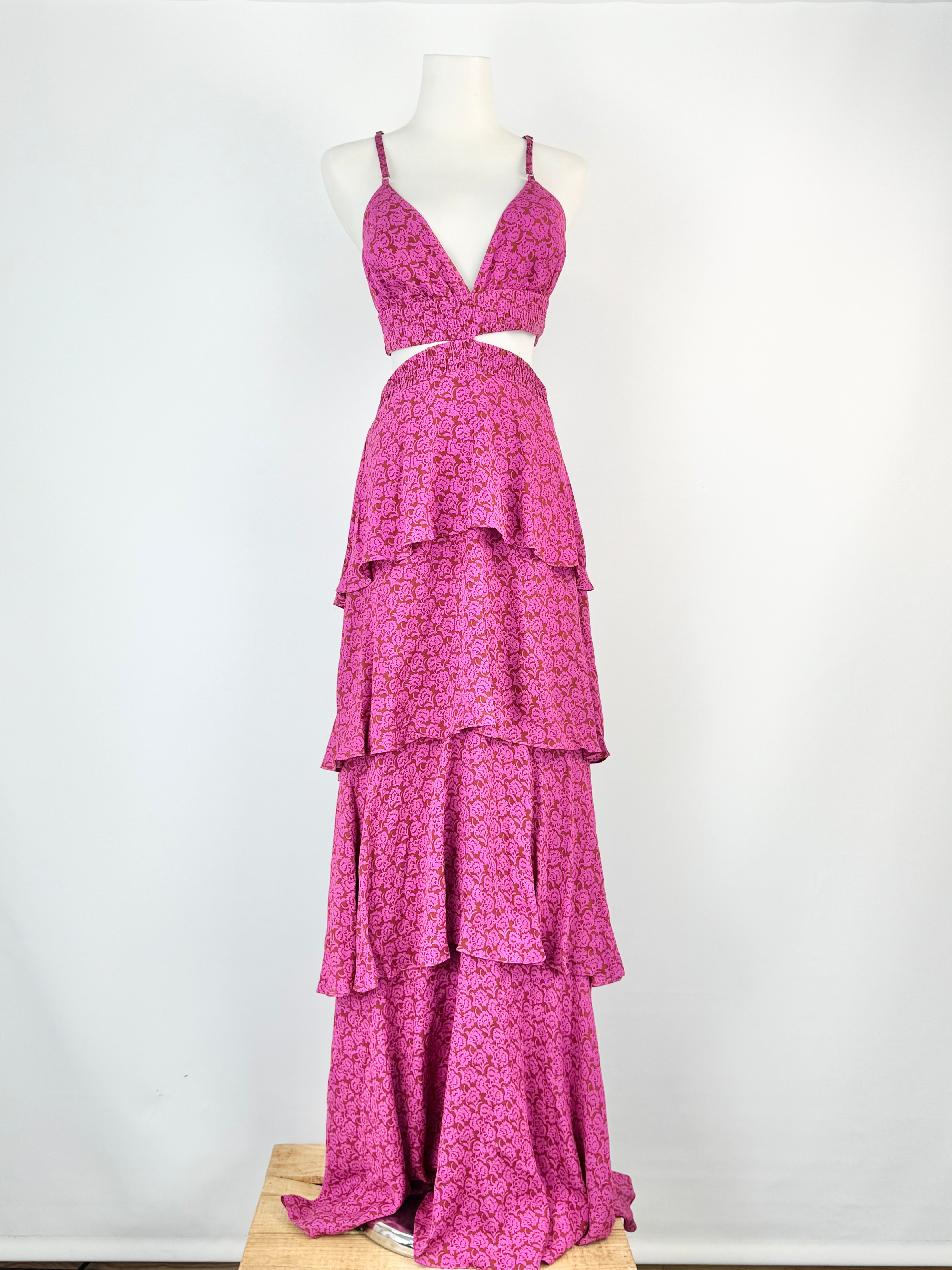 Pink floral dress on a mannequin against a white background