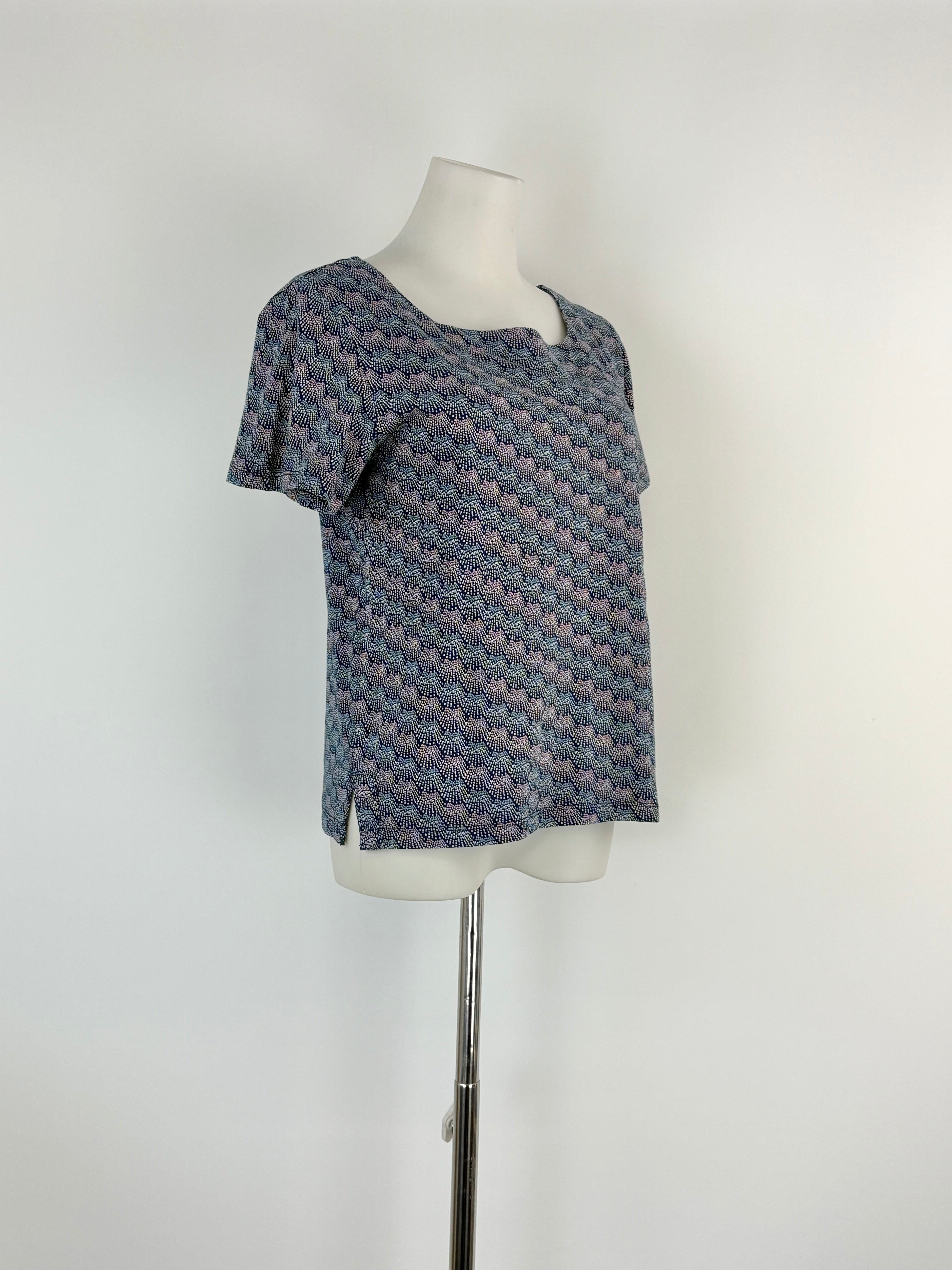 Patterned top on a mannequin against a white background