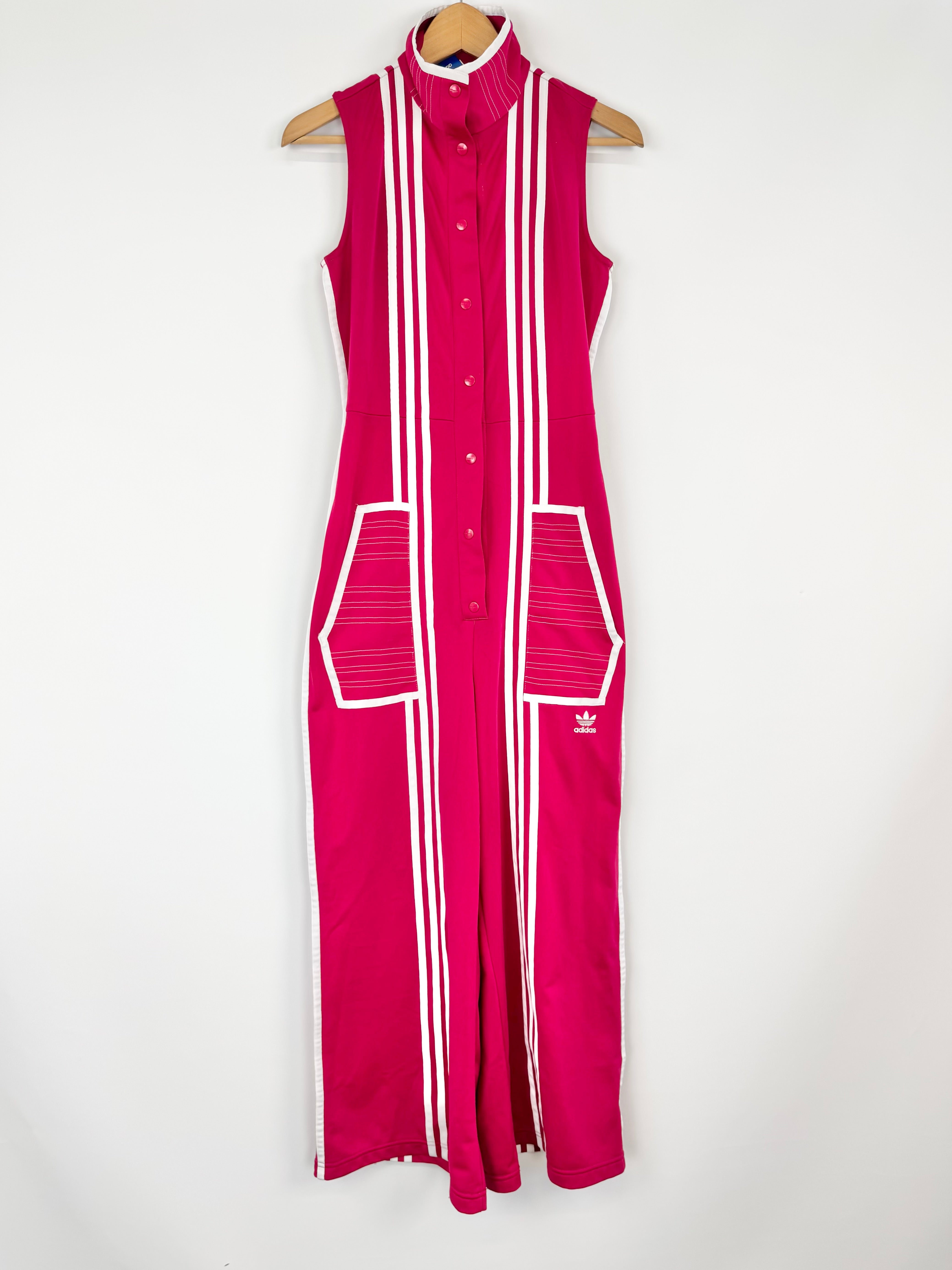 Pink sleeveless jumpsuit with white stripes and Adidas logo on a white background