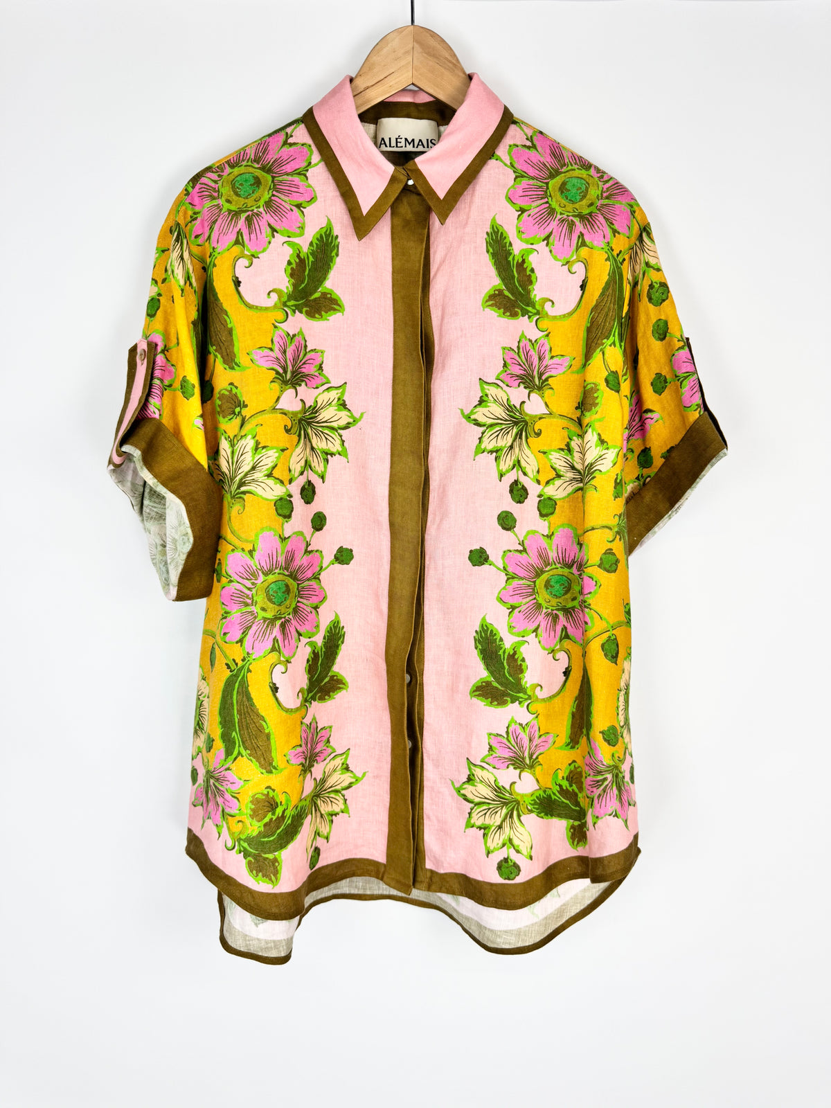 Colorful floral shirt on a hanger against a white background