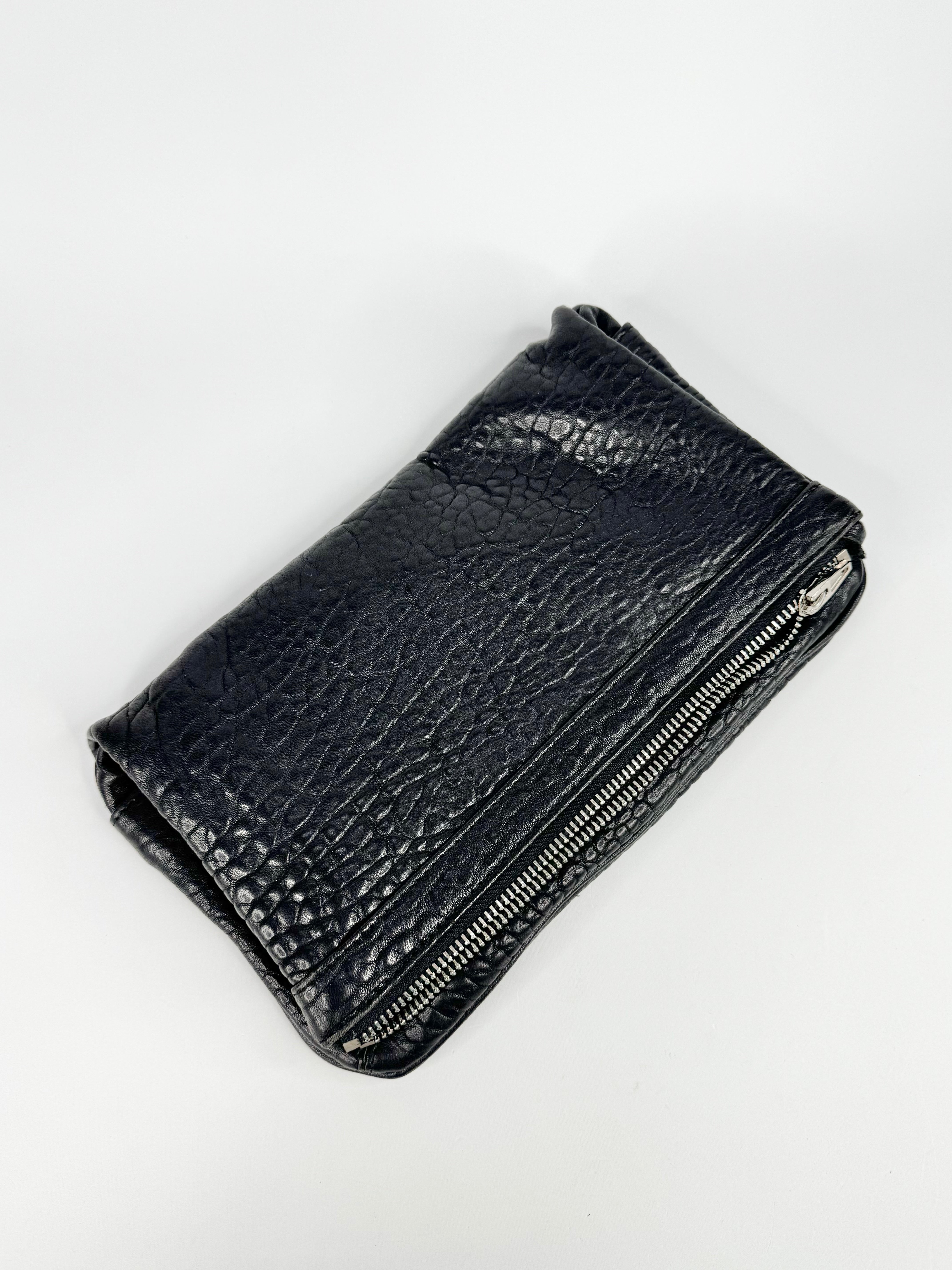 Black leather wallet with grainy texture on a white background