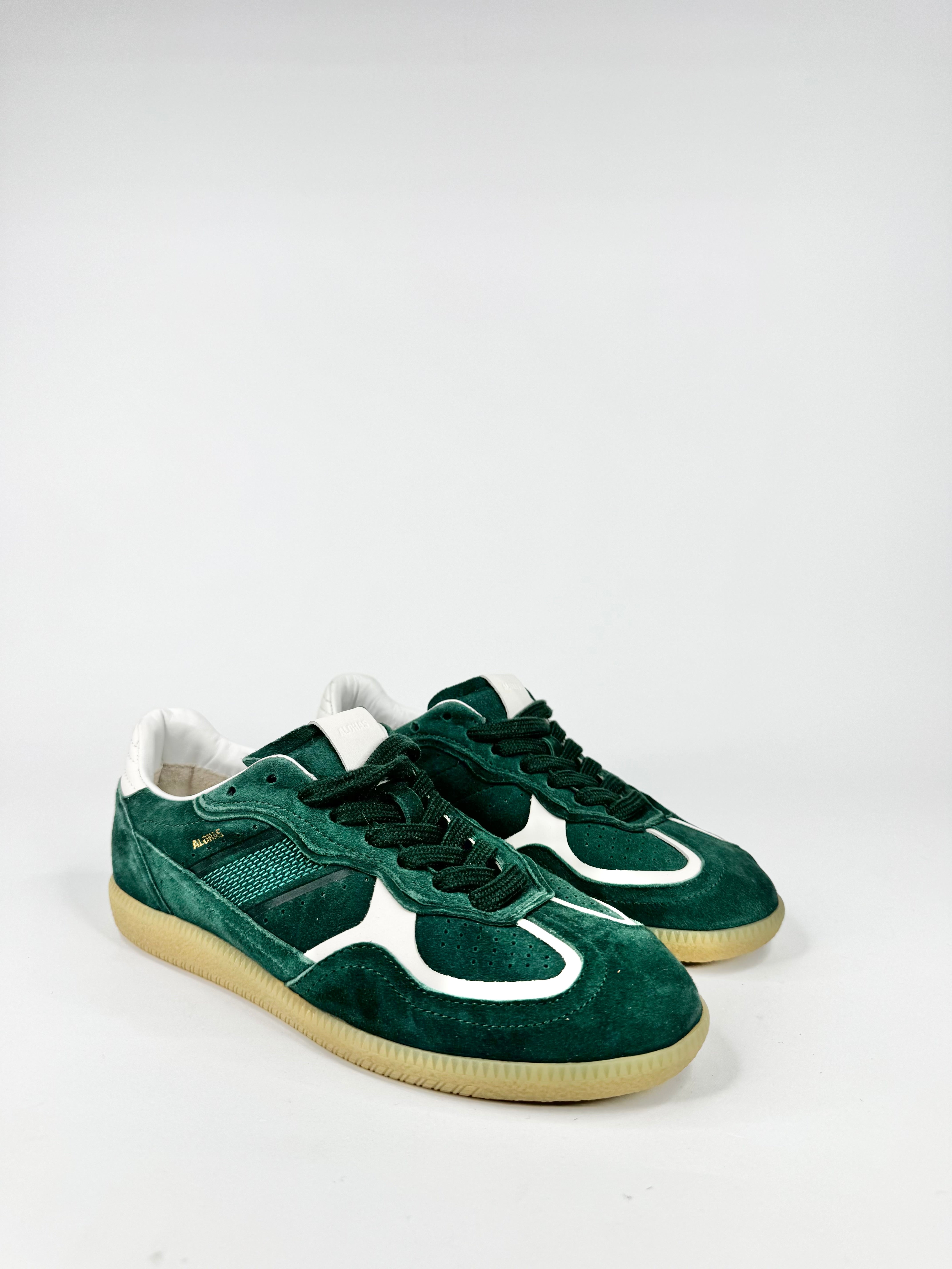 Pair of green sneakers with white accents on a light gray background