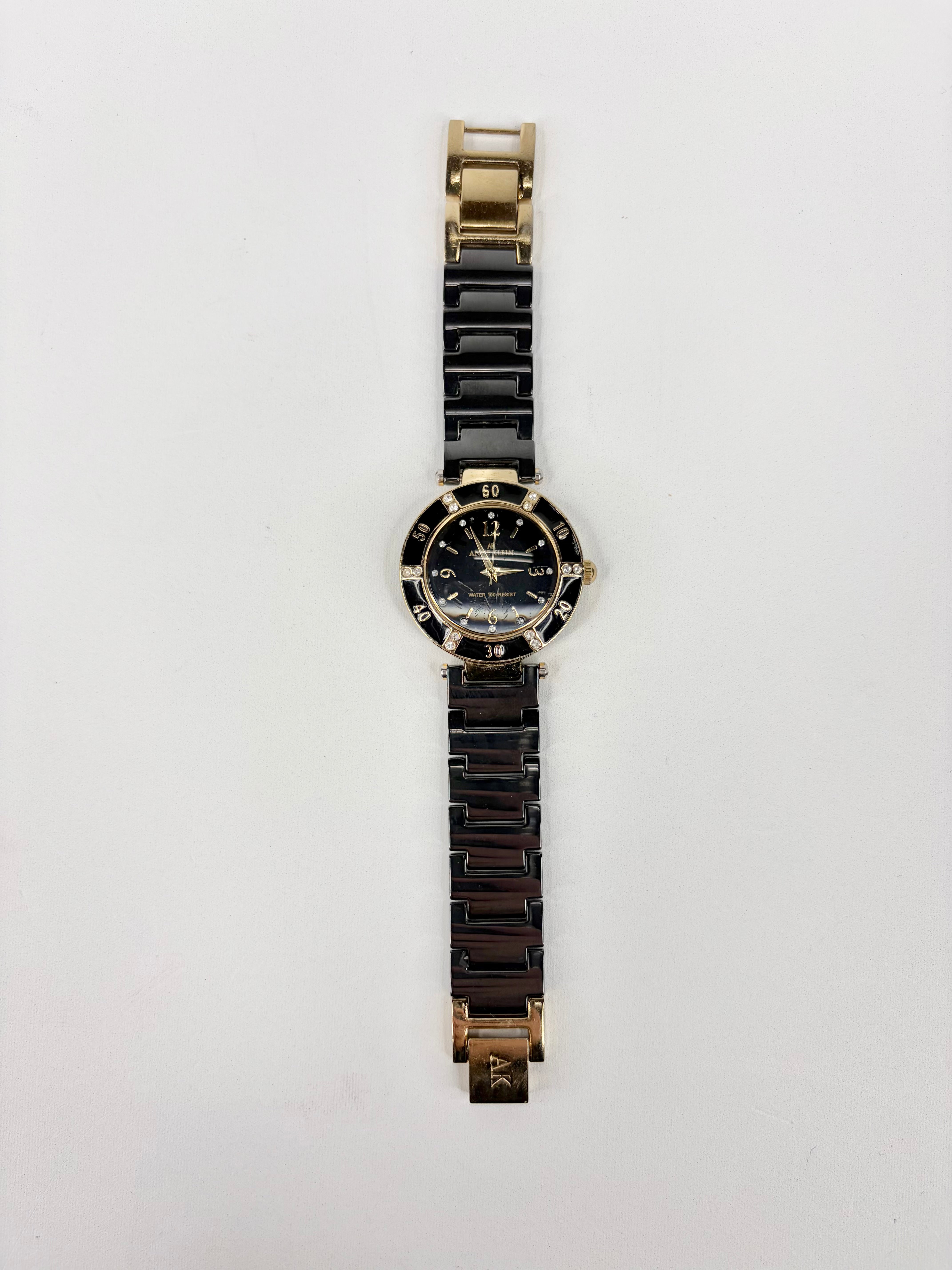 Black and gold watch on a white background