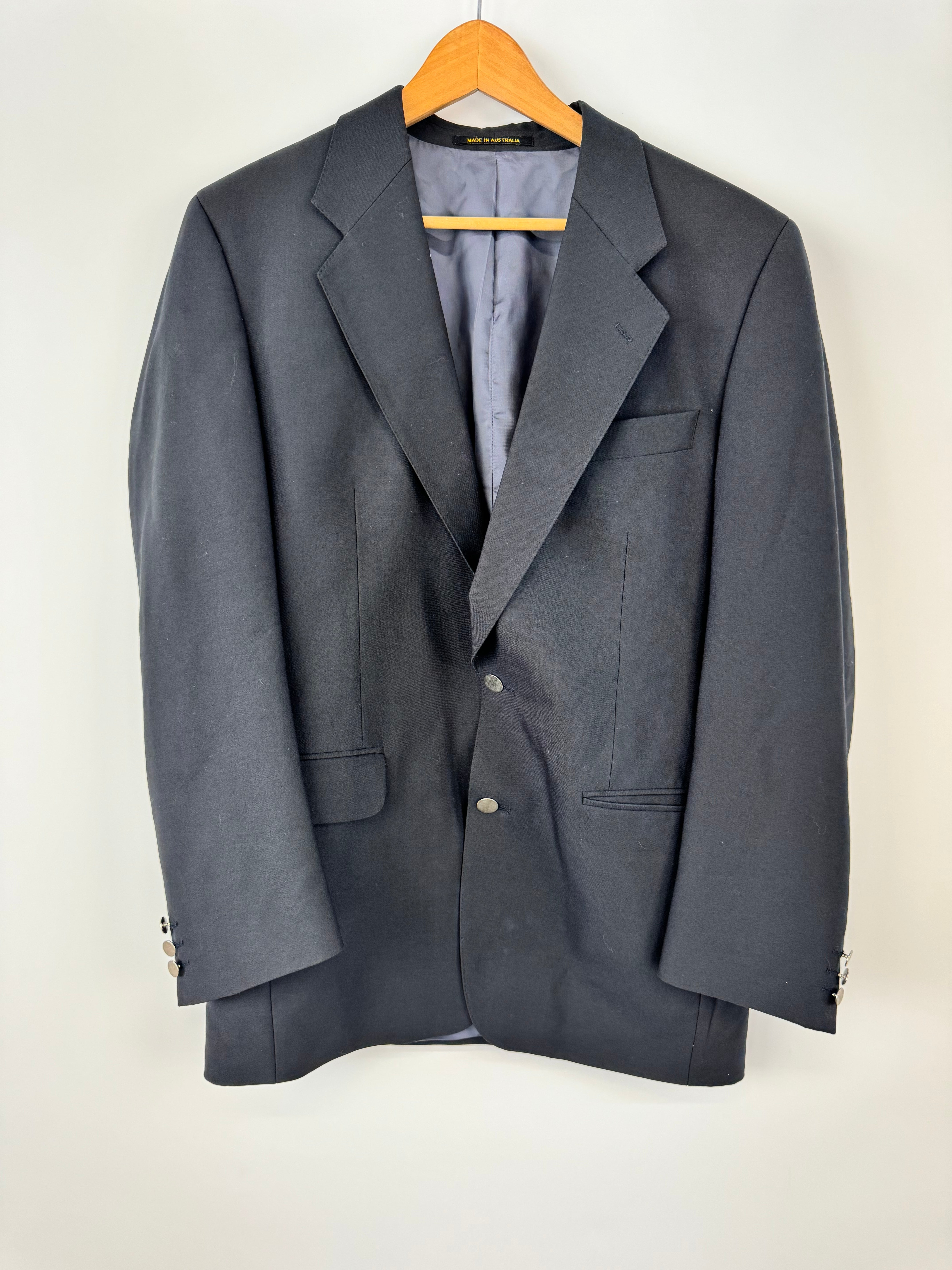 Folded gray suit jacket on a white background