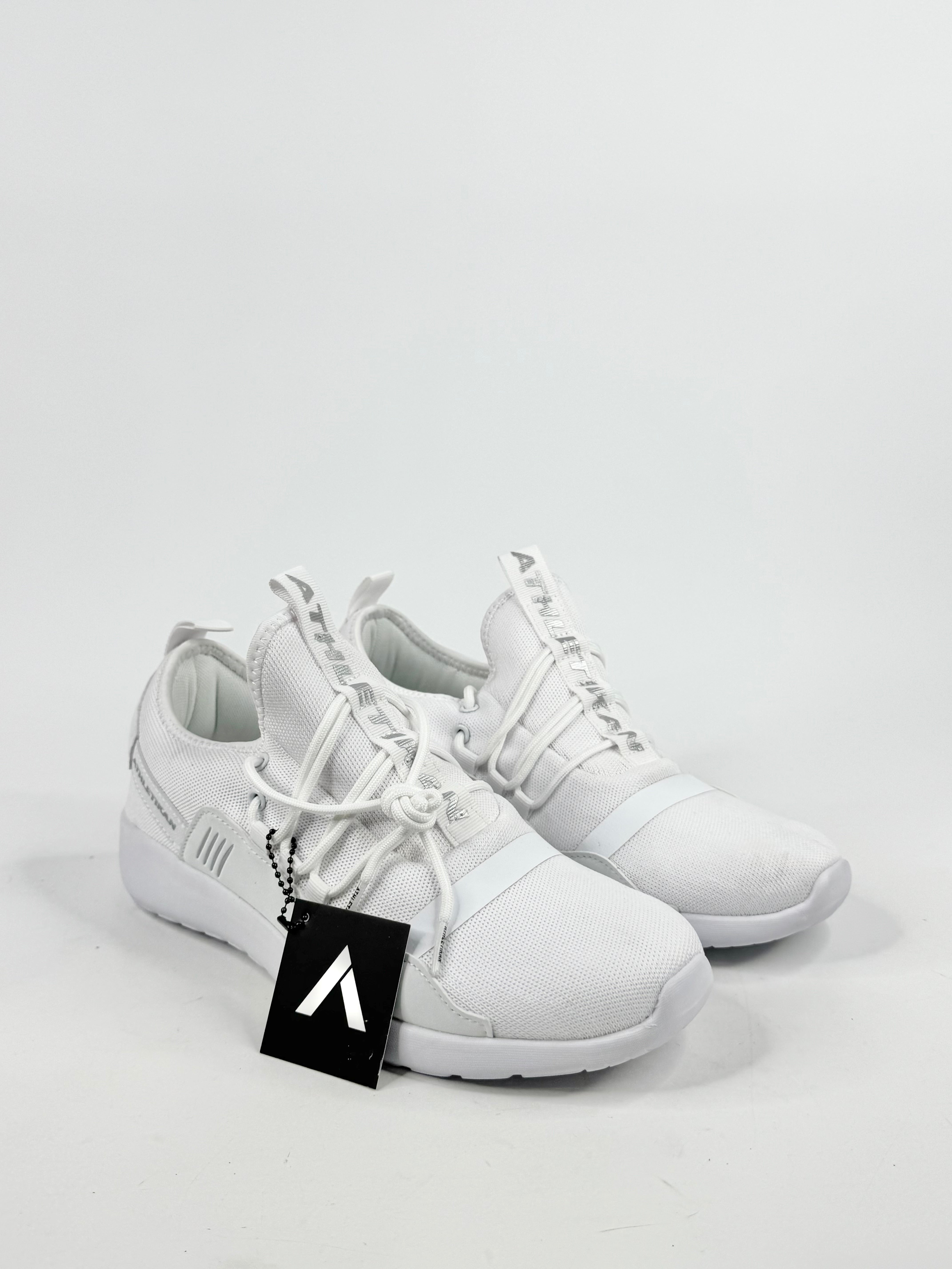 White sneakers with a brand logo tag on a light gray background