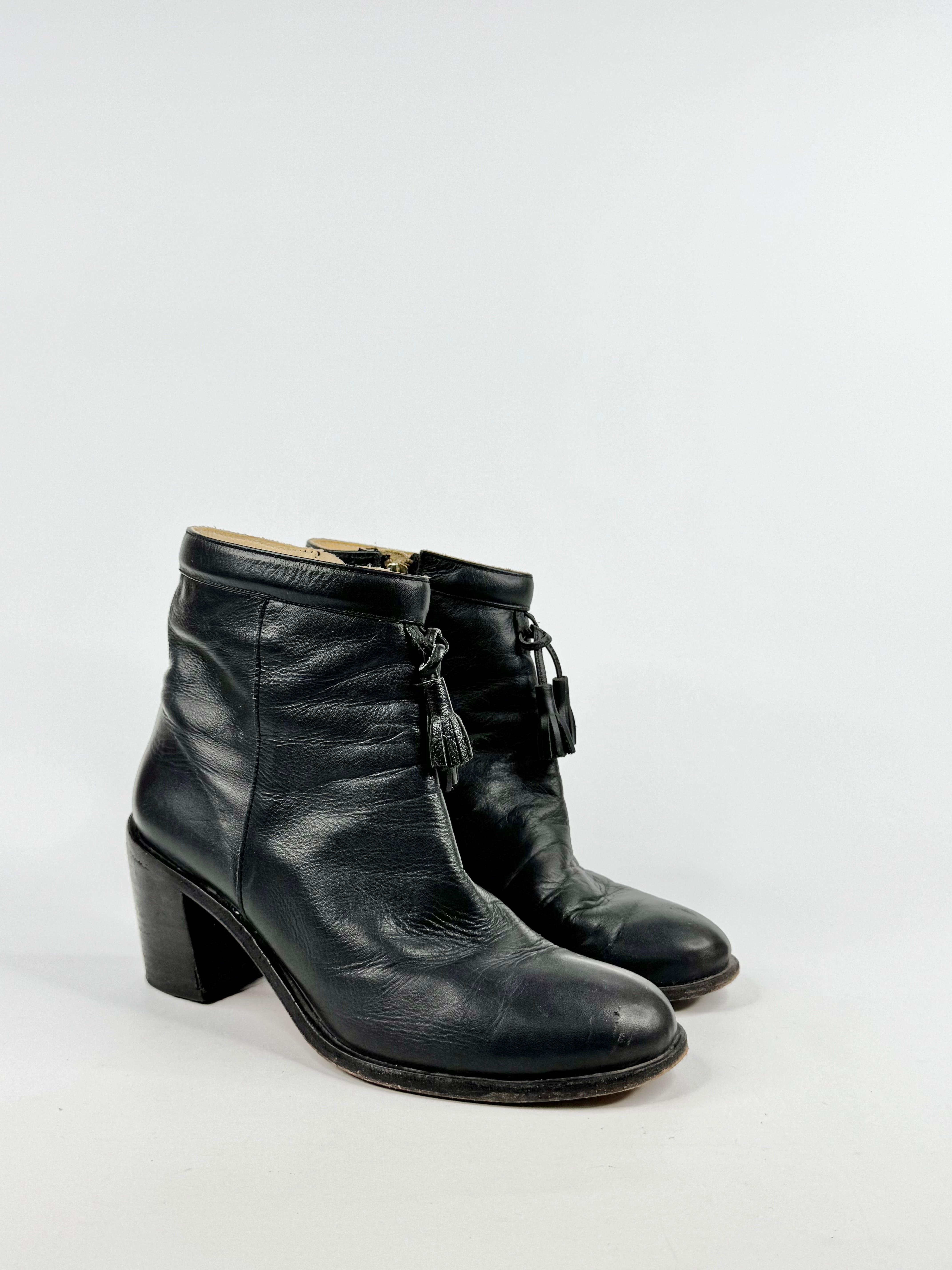Pair of black leather boots on a white background
