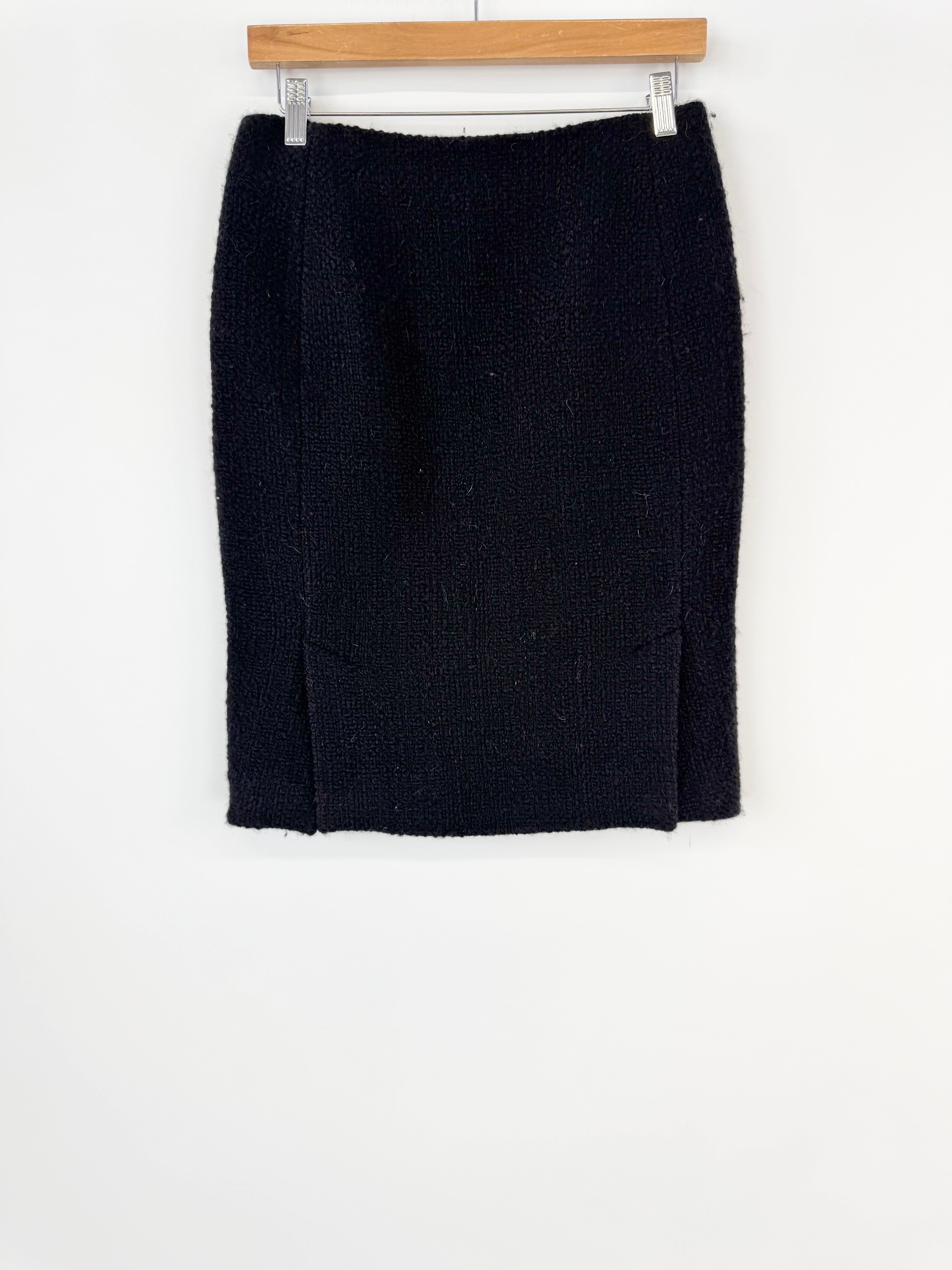 Black skirt on a hanger against a white background