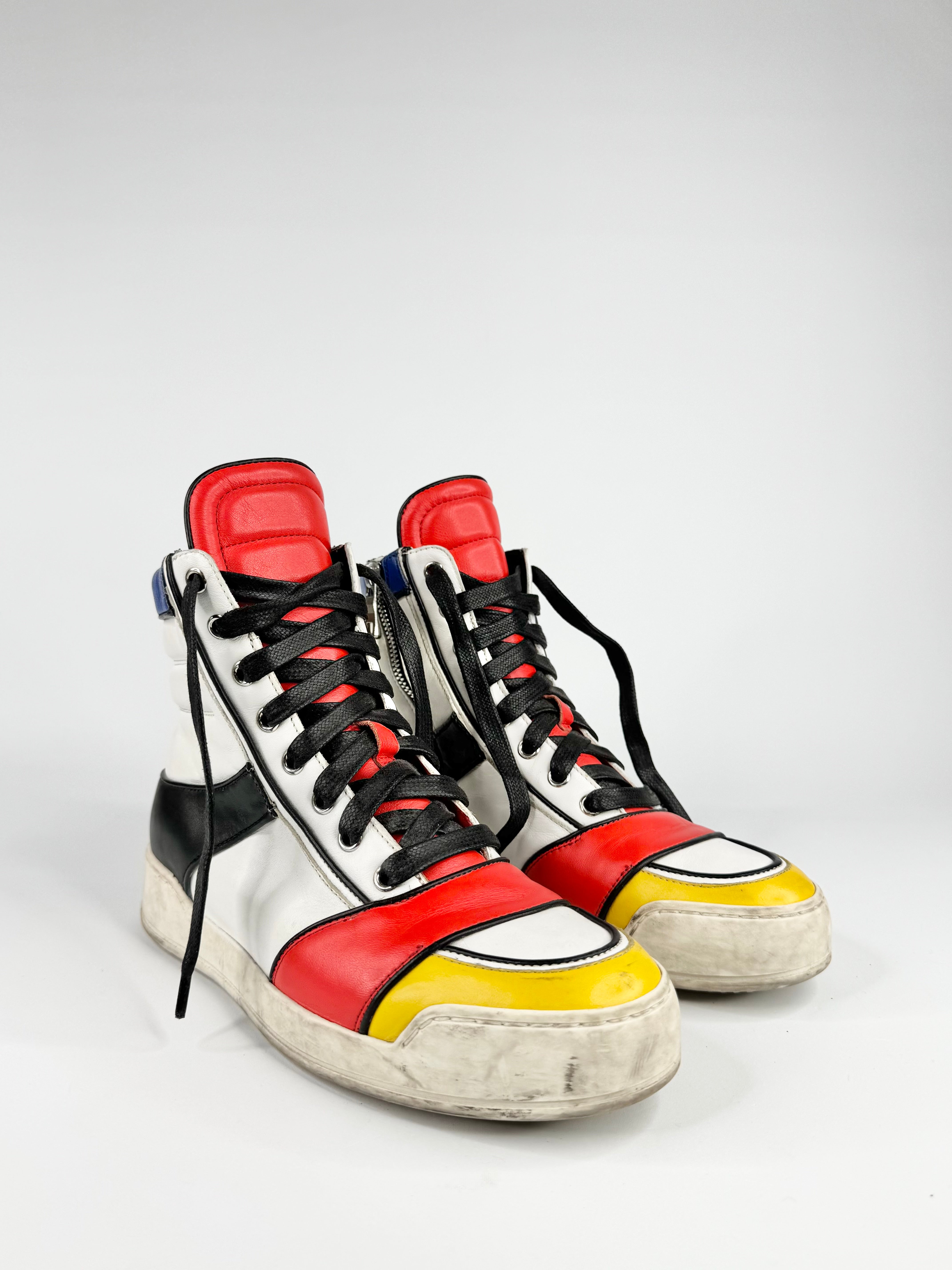 Colorful high-top sneakers with red, yellow, and black accents on a white background