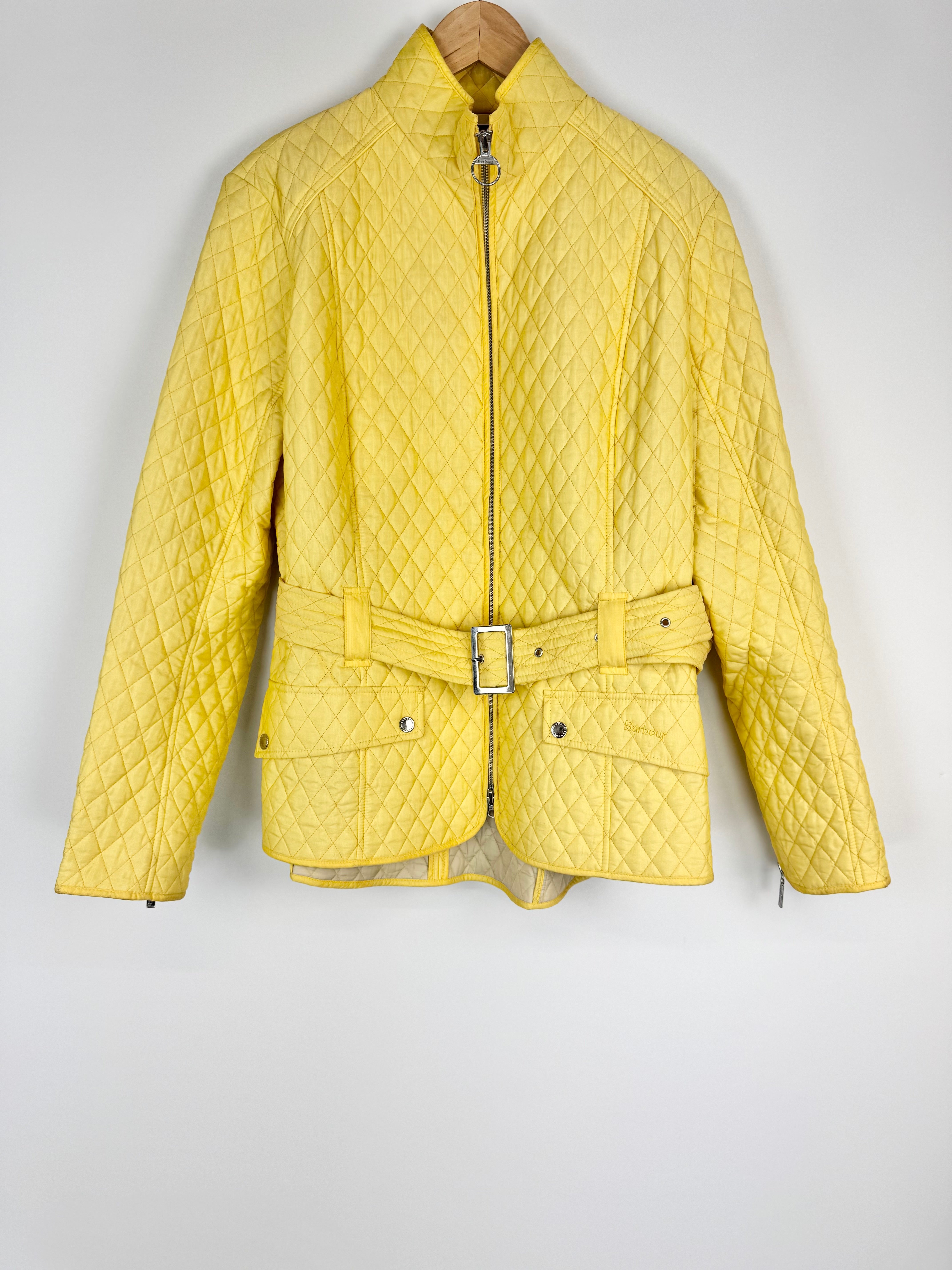 Yellow quilted jacket with a belt on a white background