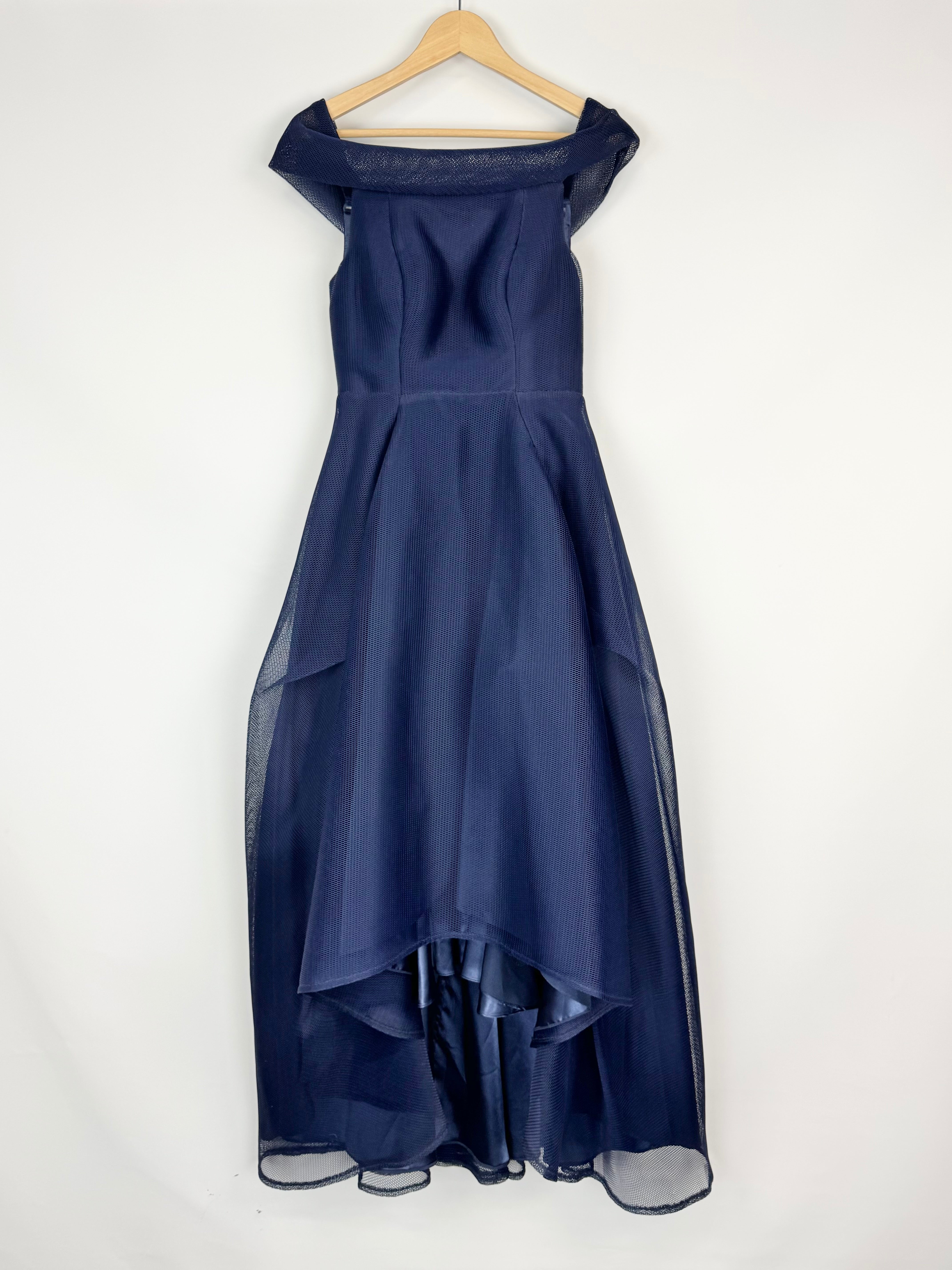 Navy blue evening gown on a hanger against a white background