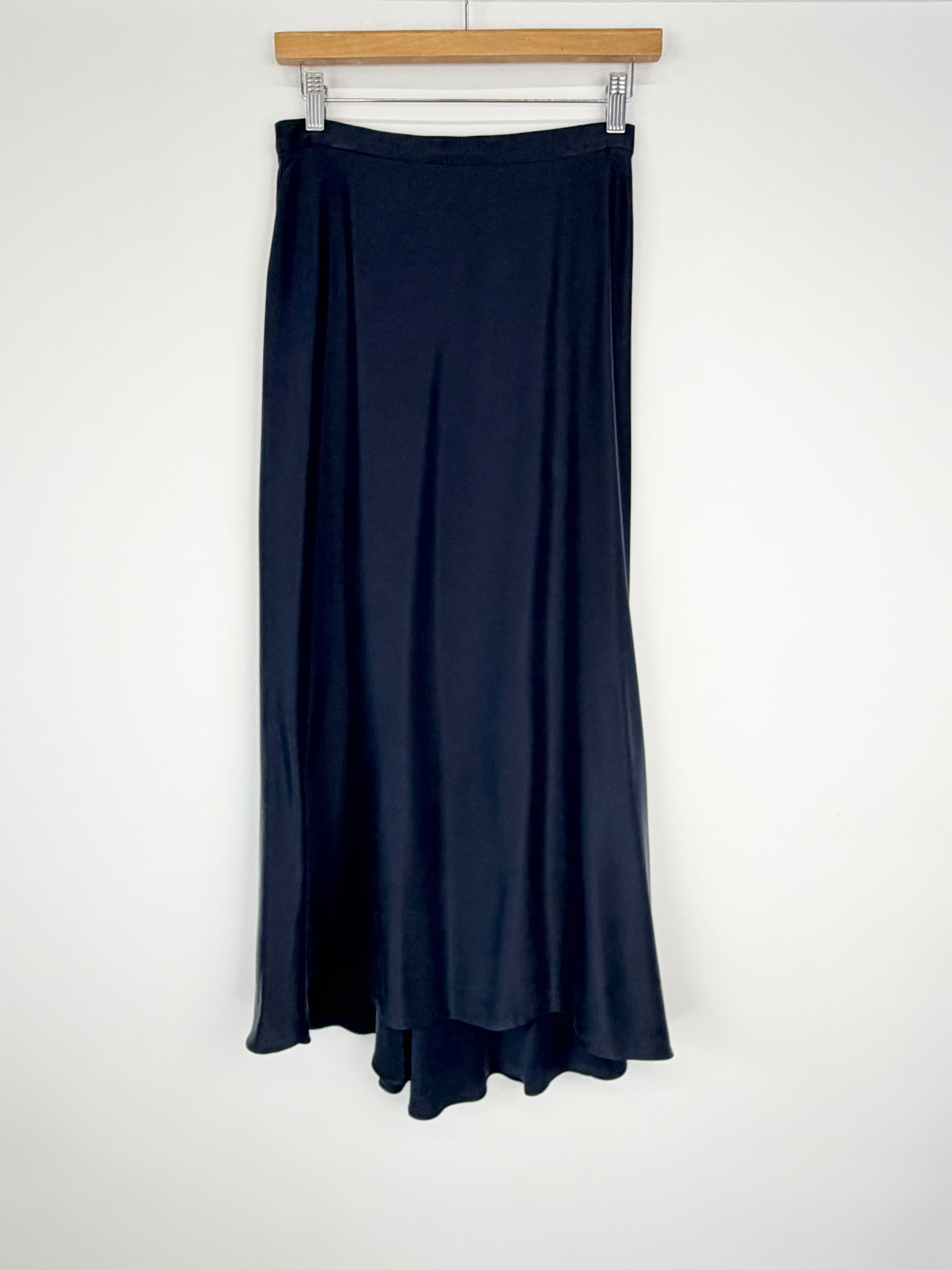 Navy blue skirt on a hanger against a white background