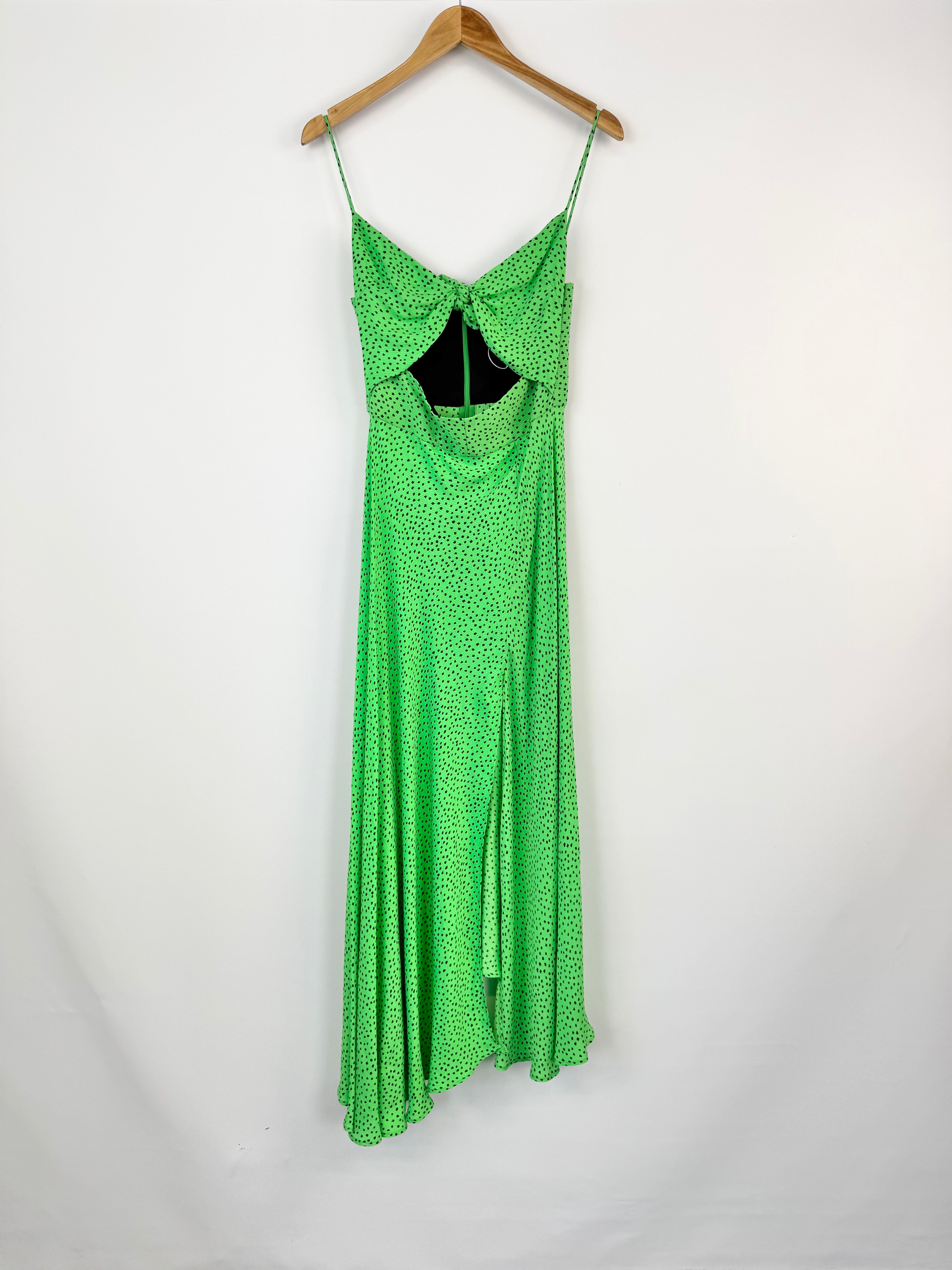 Green dress on a hanger against a white background