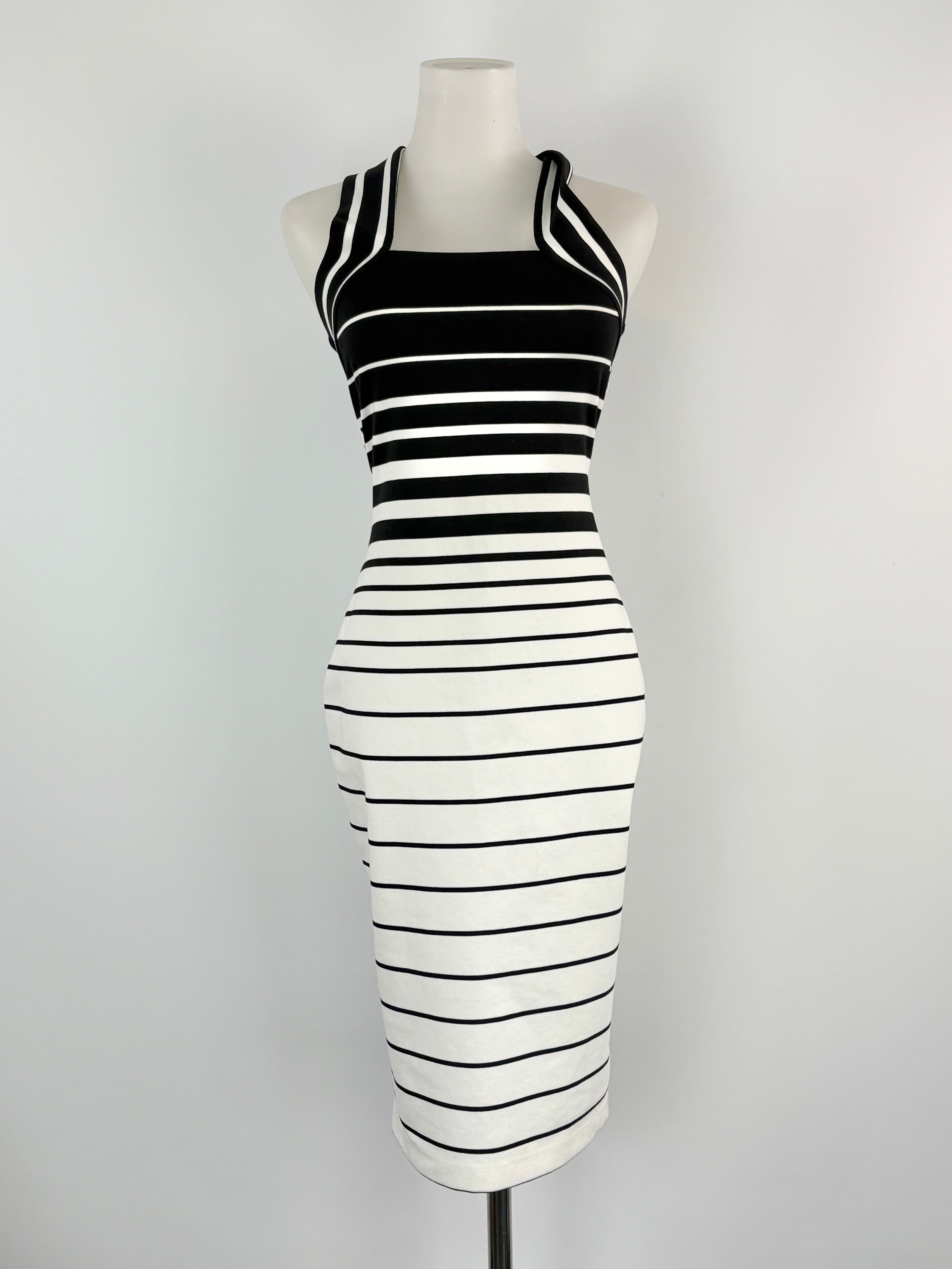 Black and white striped dress on a mannequin against a gray background