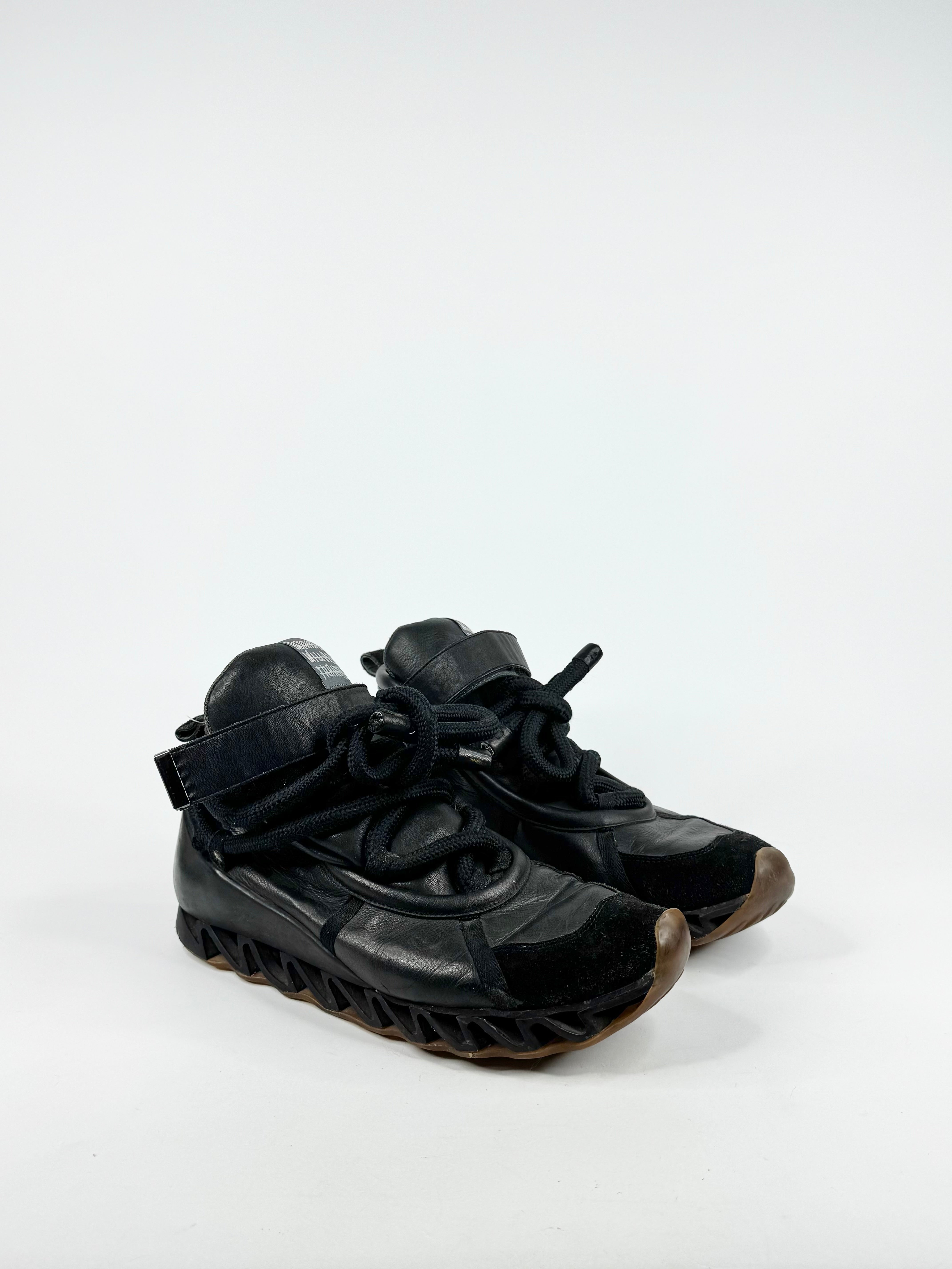 Black high-top sneakers on a white background