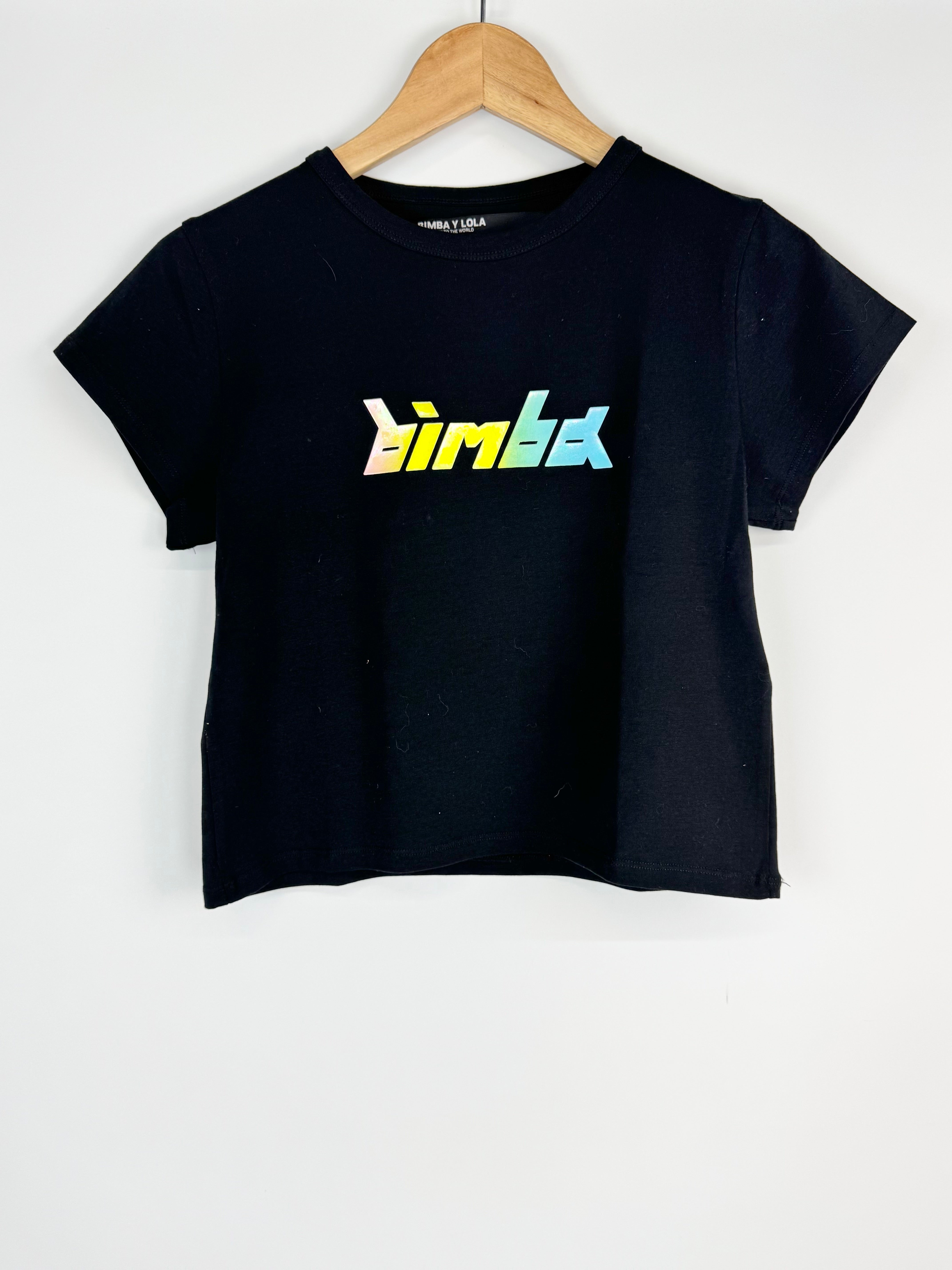 Black t-shirt with colorful logo on a hanger against a white background