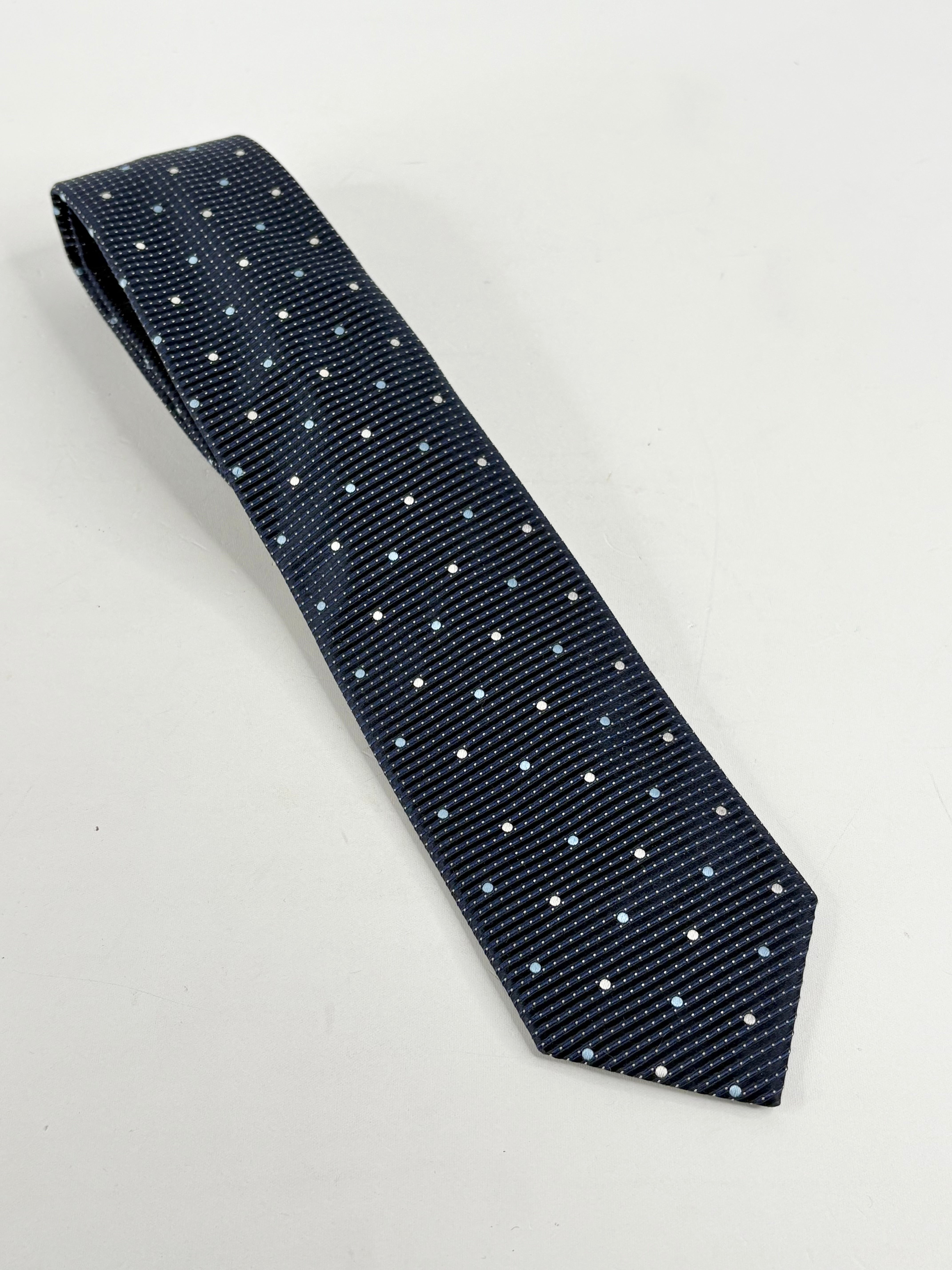 Navy blue silk tie with a micro dot pattern.