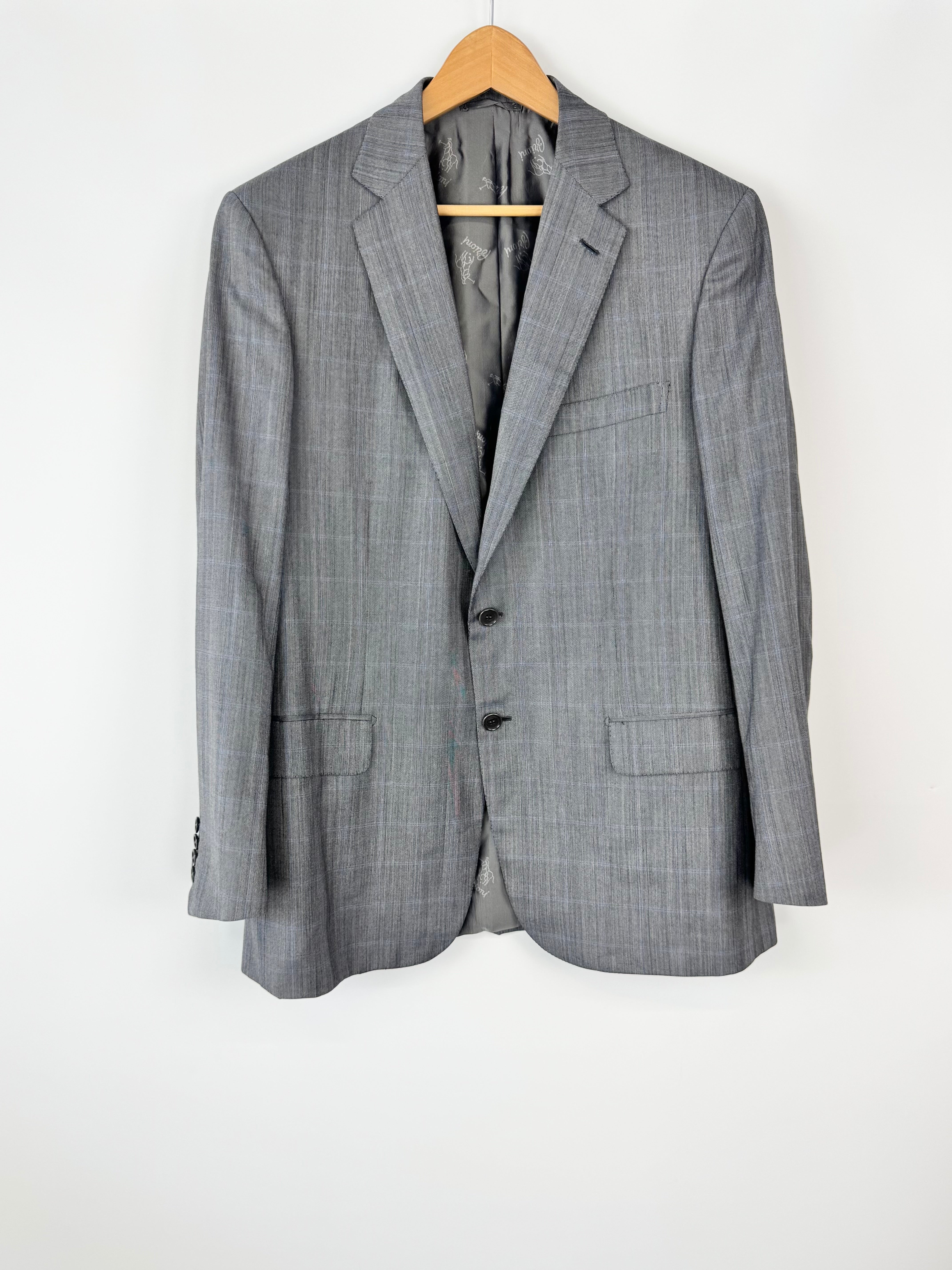 Gray checkered suit jacket on a hanger against a white background