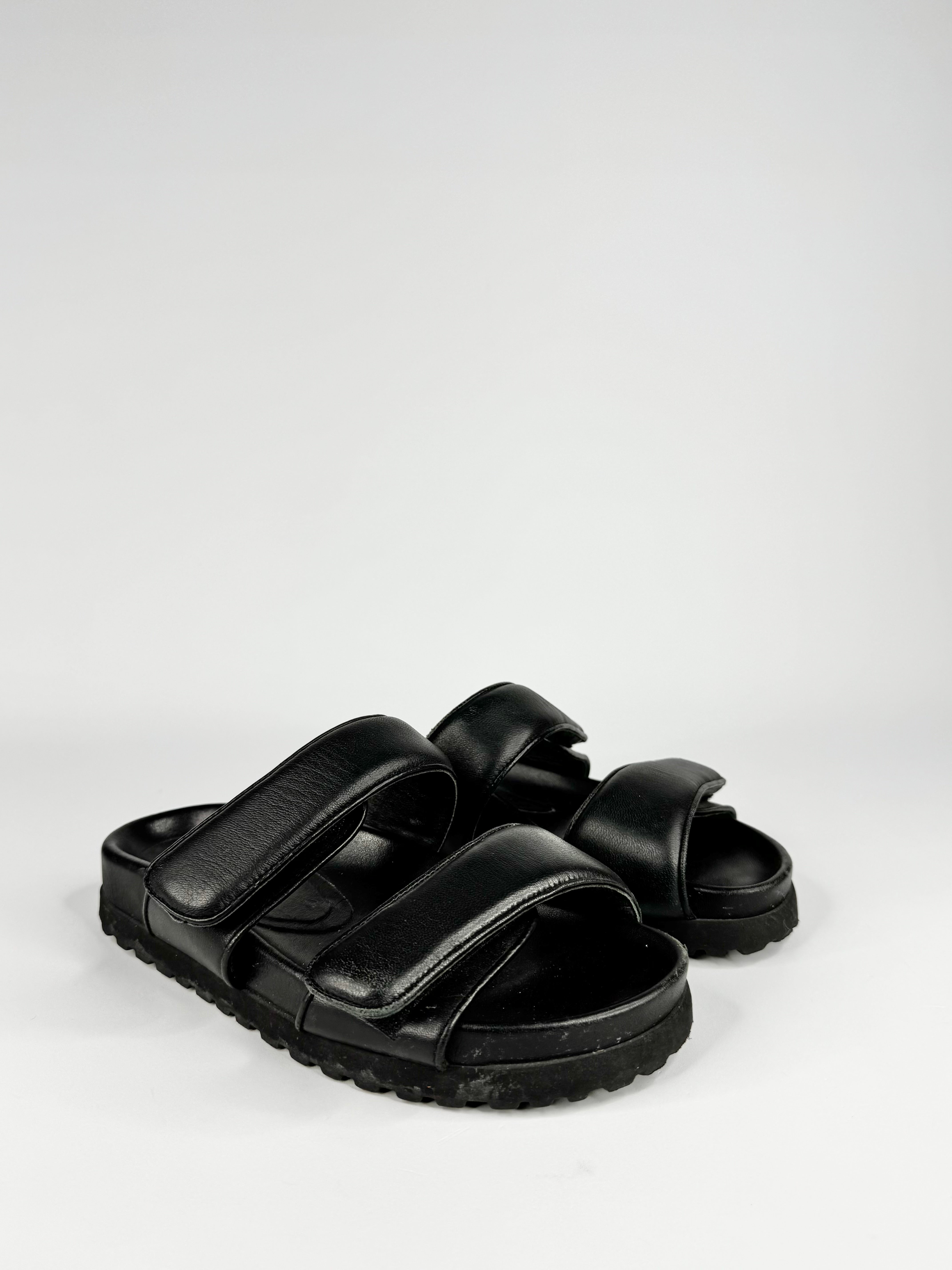 Black sandals on a light gray background