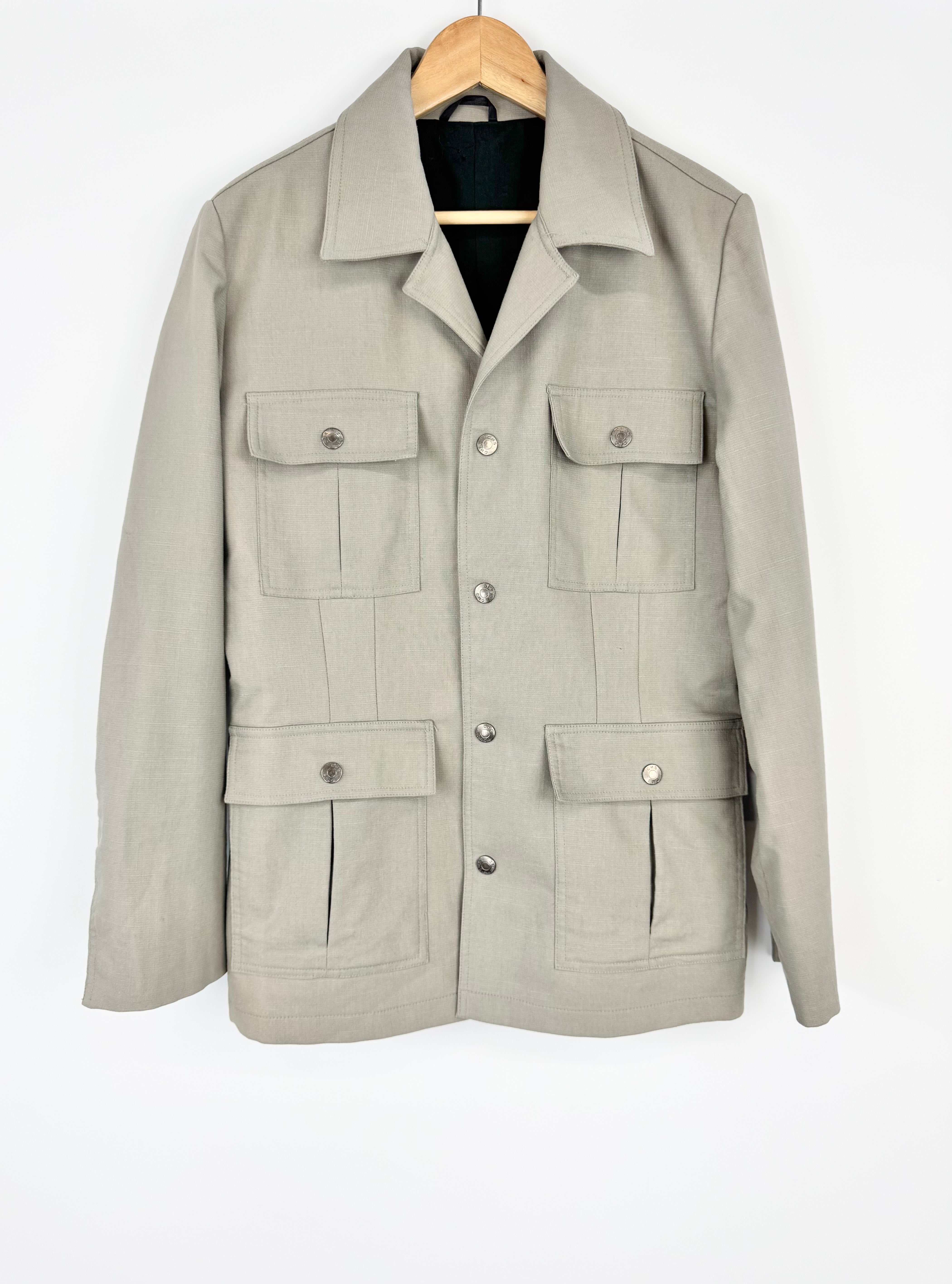 Light gray jacket with multiple pockets on a white background