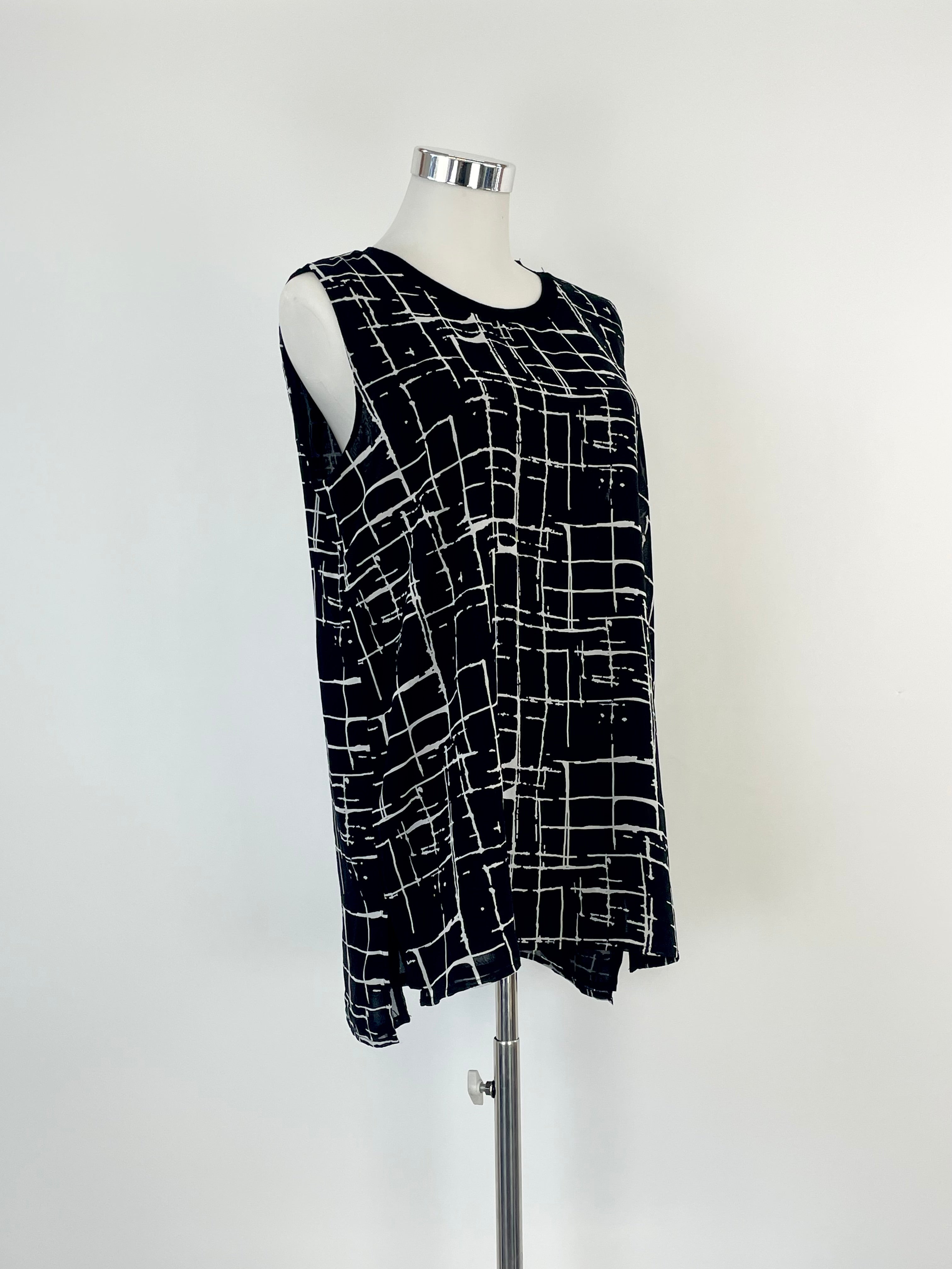 A black and white geometric print Calvin Klein tank top on a mannequin against a white background.