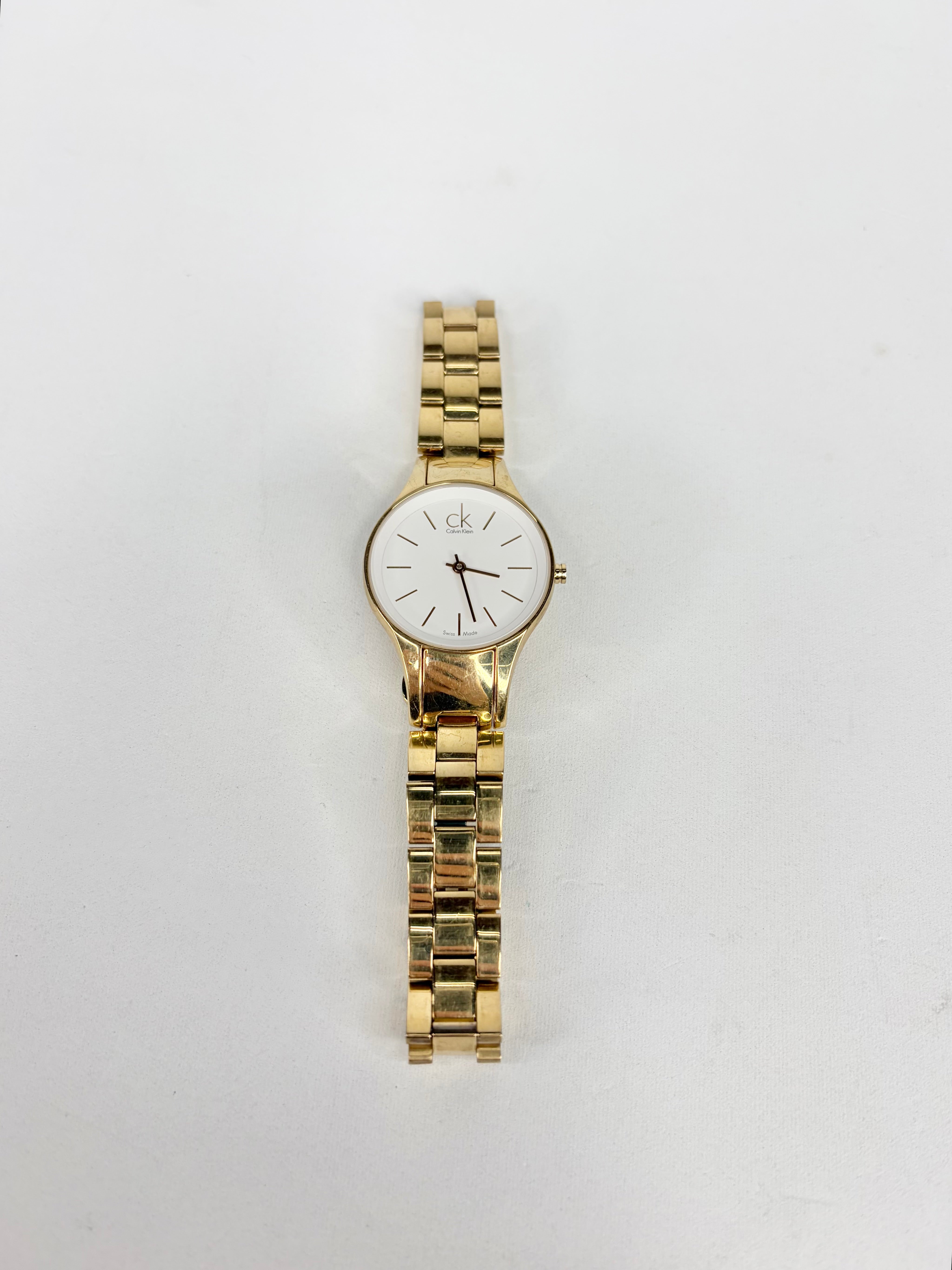 Gold wristwatch on a white background