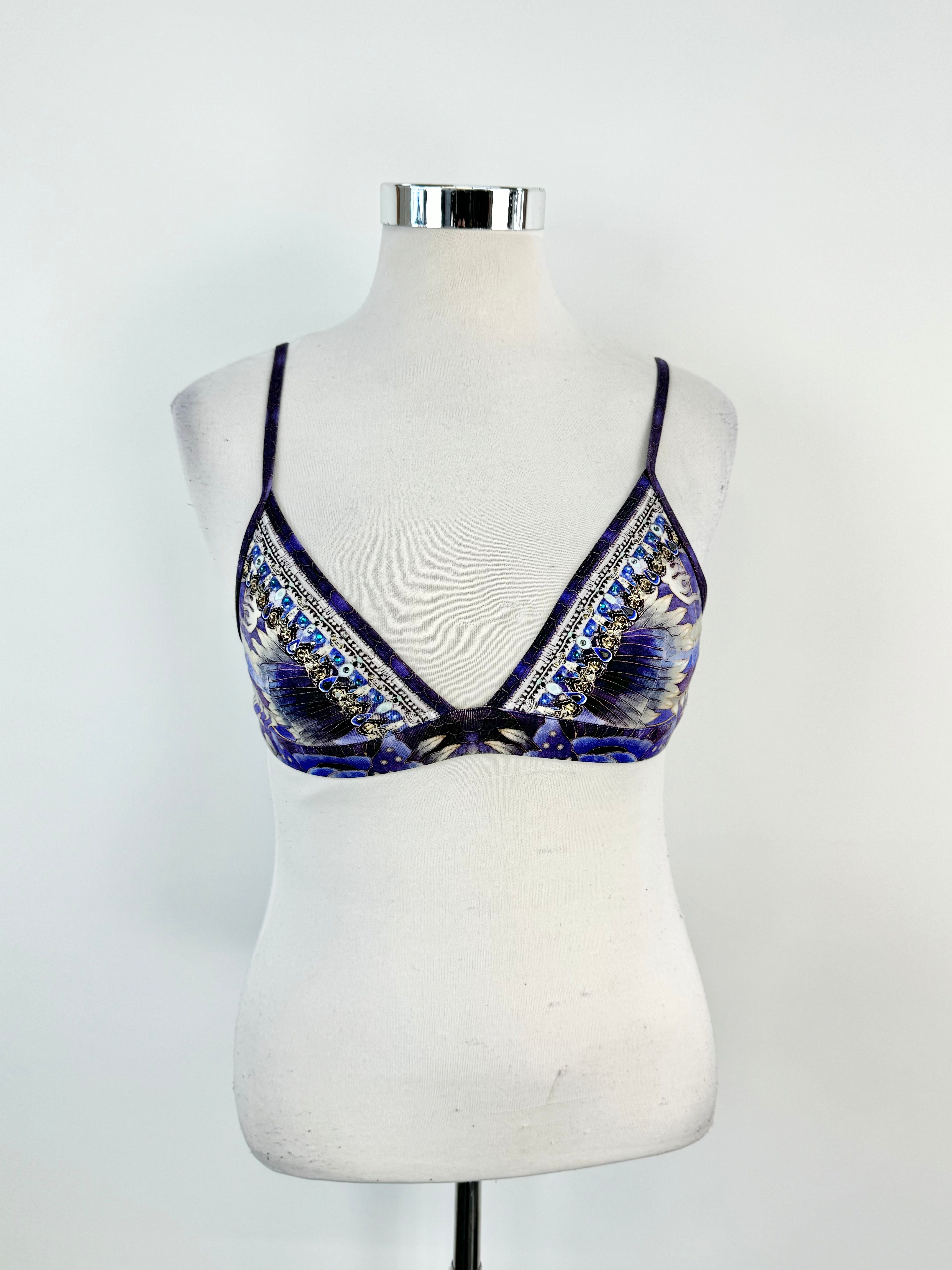 A blue patterned crystal embellished bralette displayed on a mannequin.