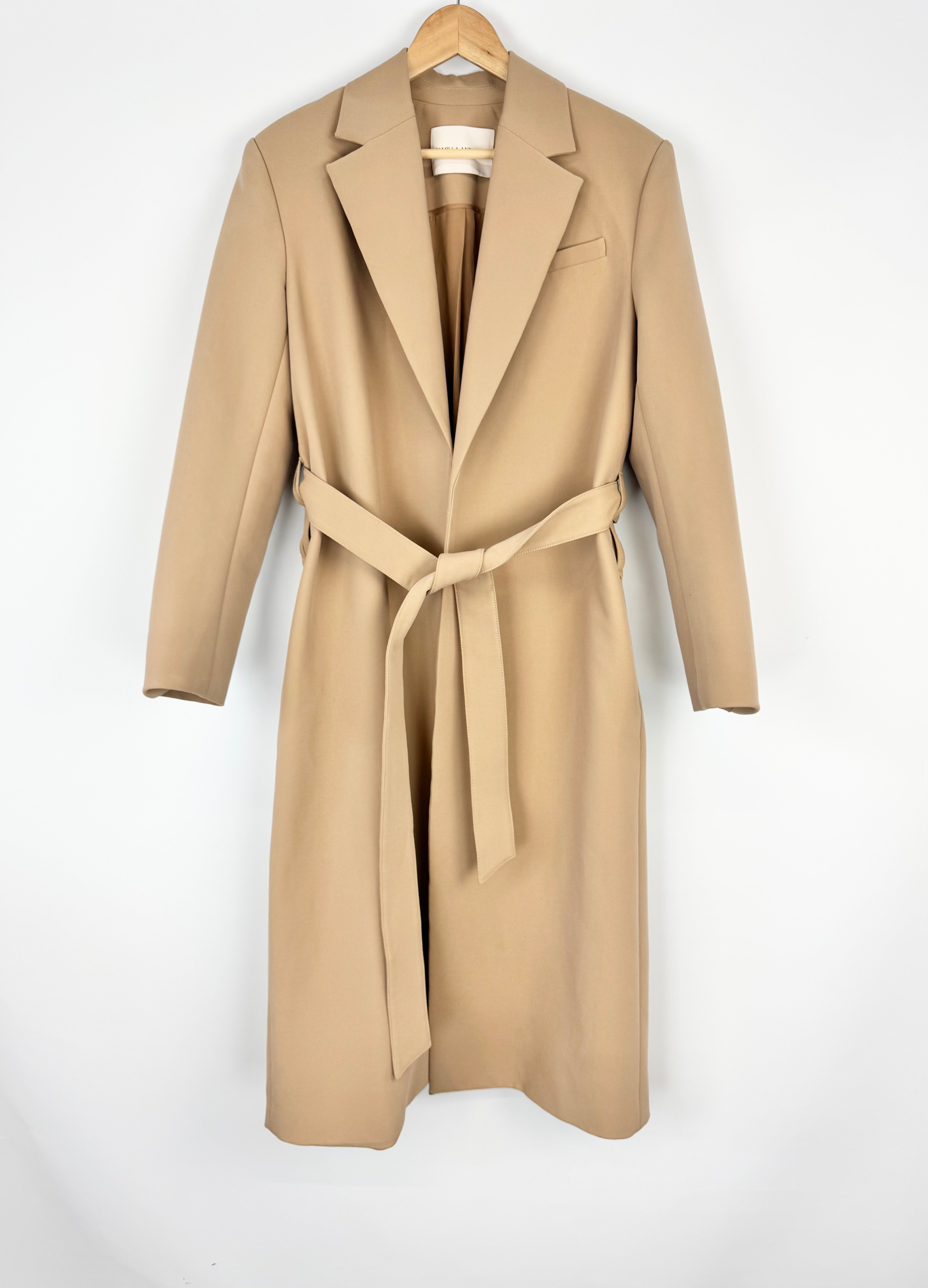 Beige trench coat on a hanger against a white background