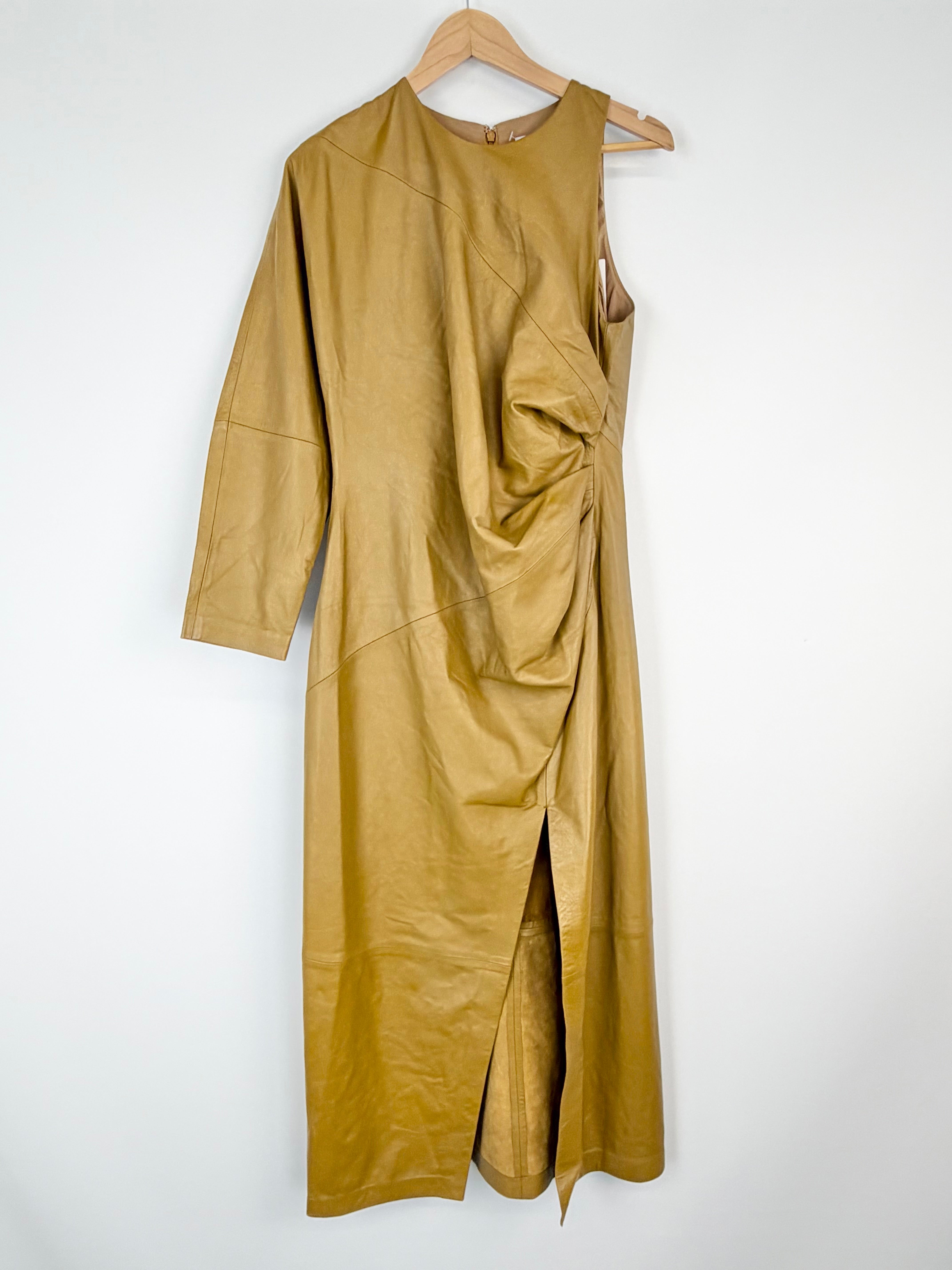 Gold dress on a hanger against a white background
