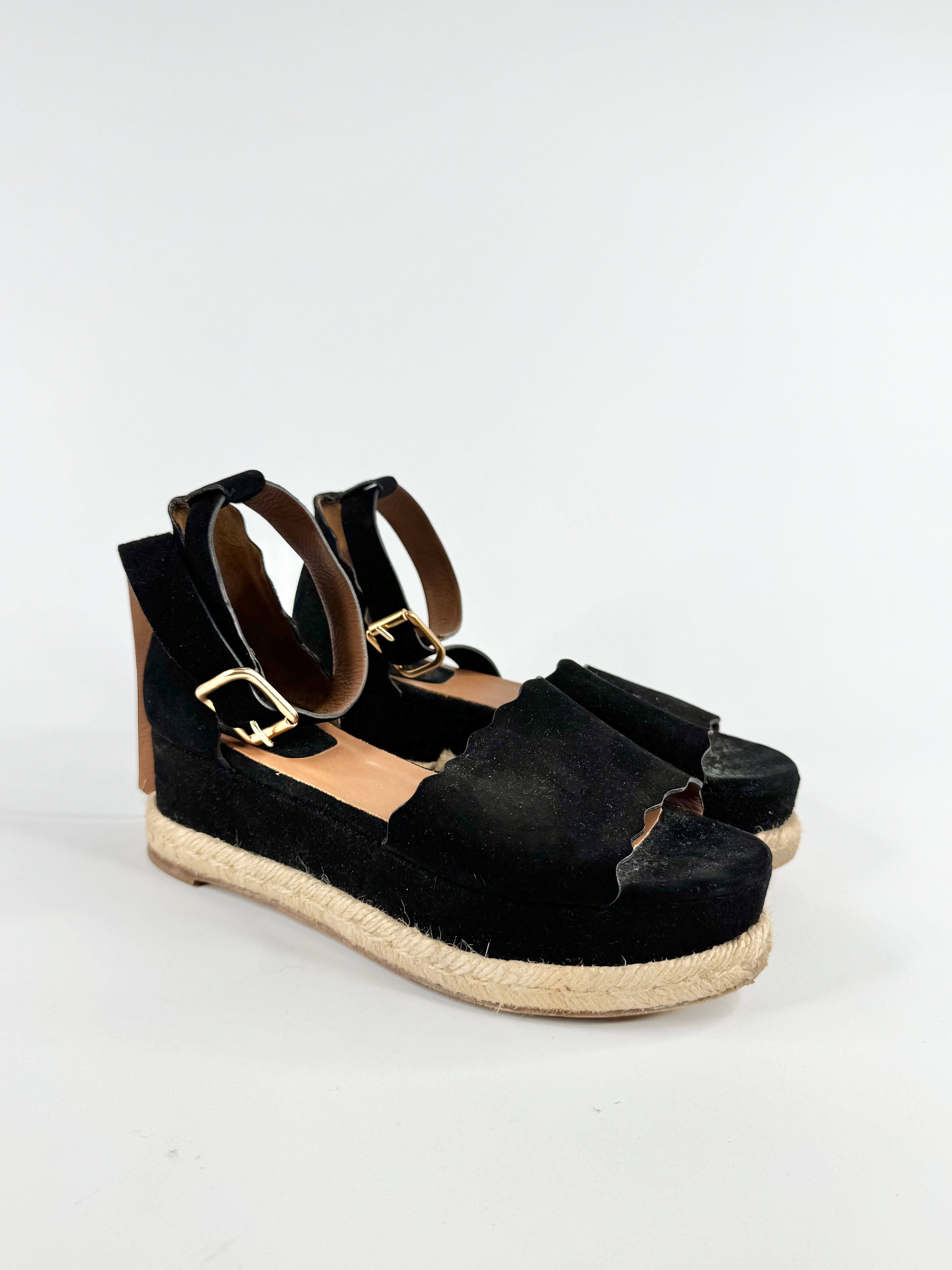 Black espadrille wedge sandals on a white background