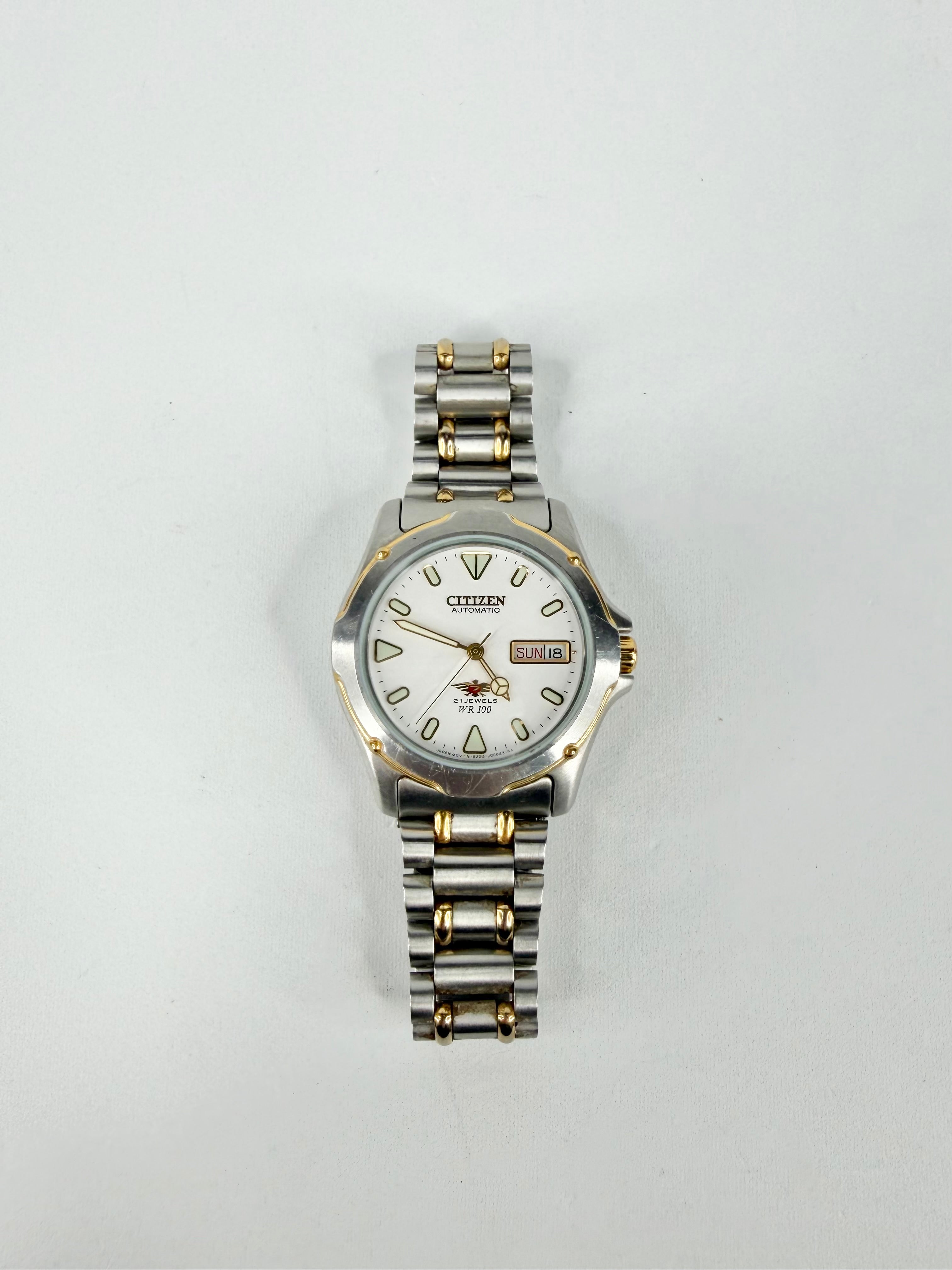 Two-tone Citizen watch on a light gray background