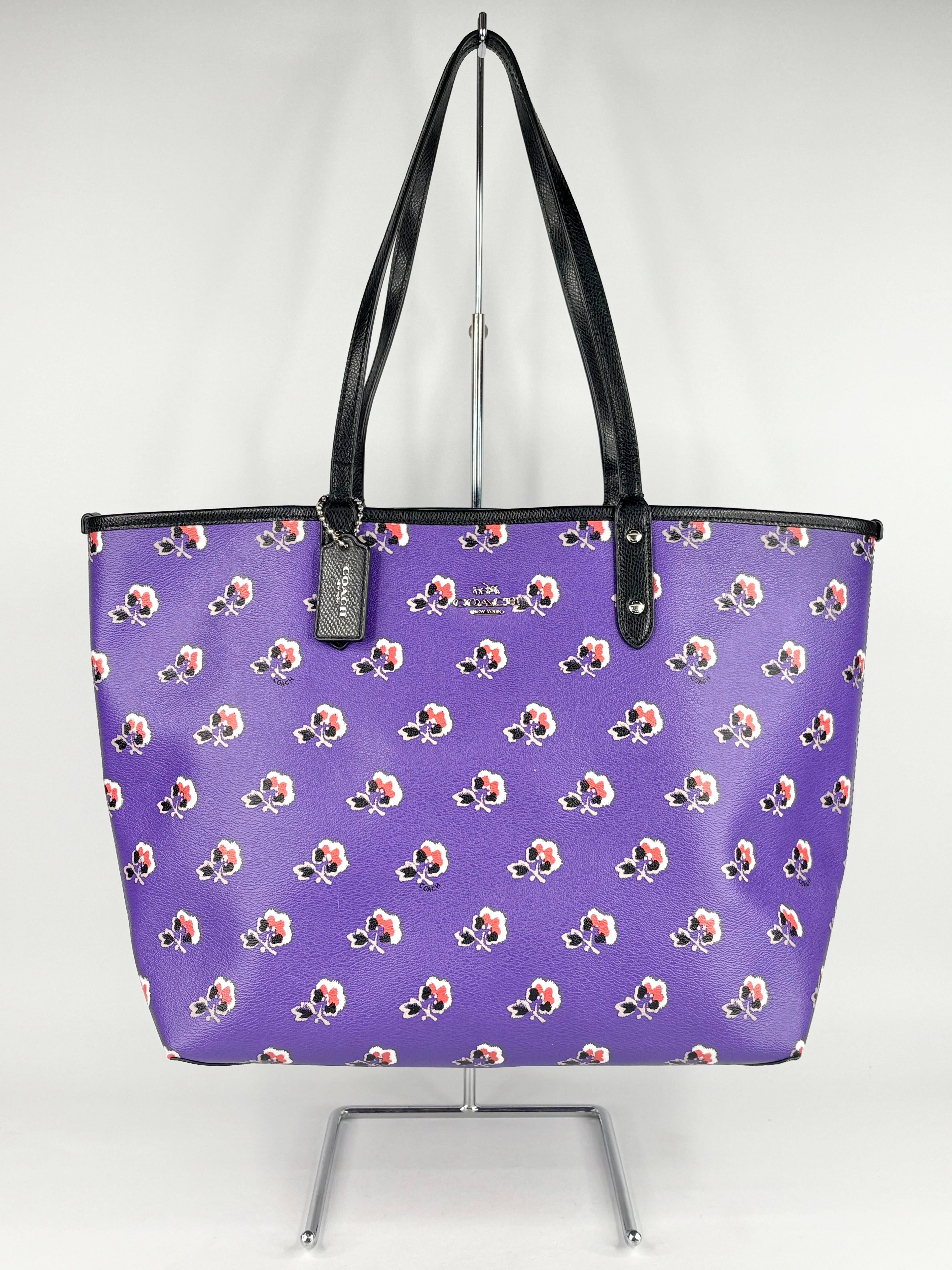 Purple tote bag with floral pattern on a white background