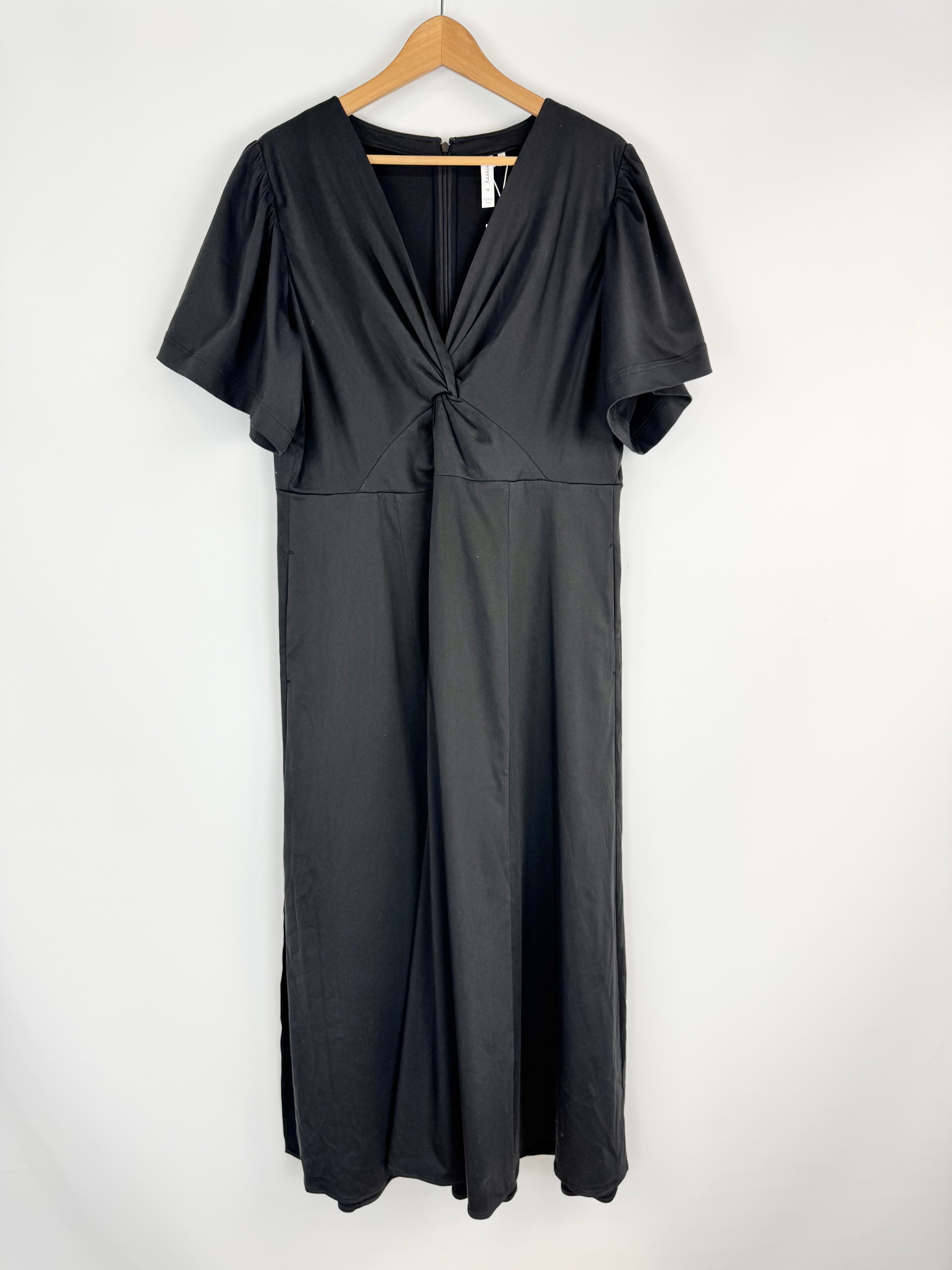 Black dress on a hanger against a white background