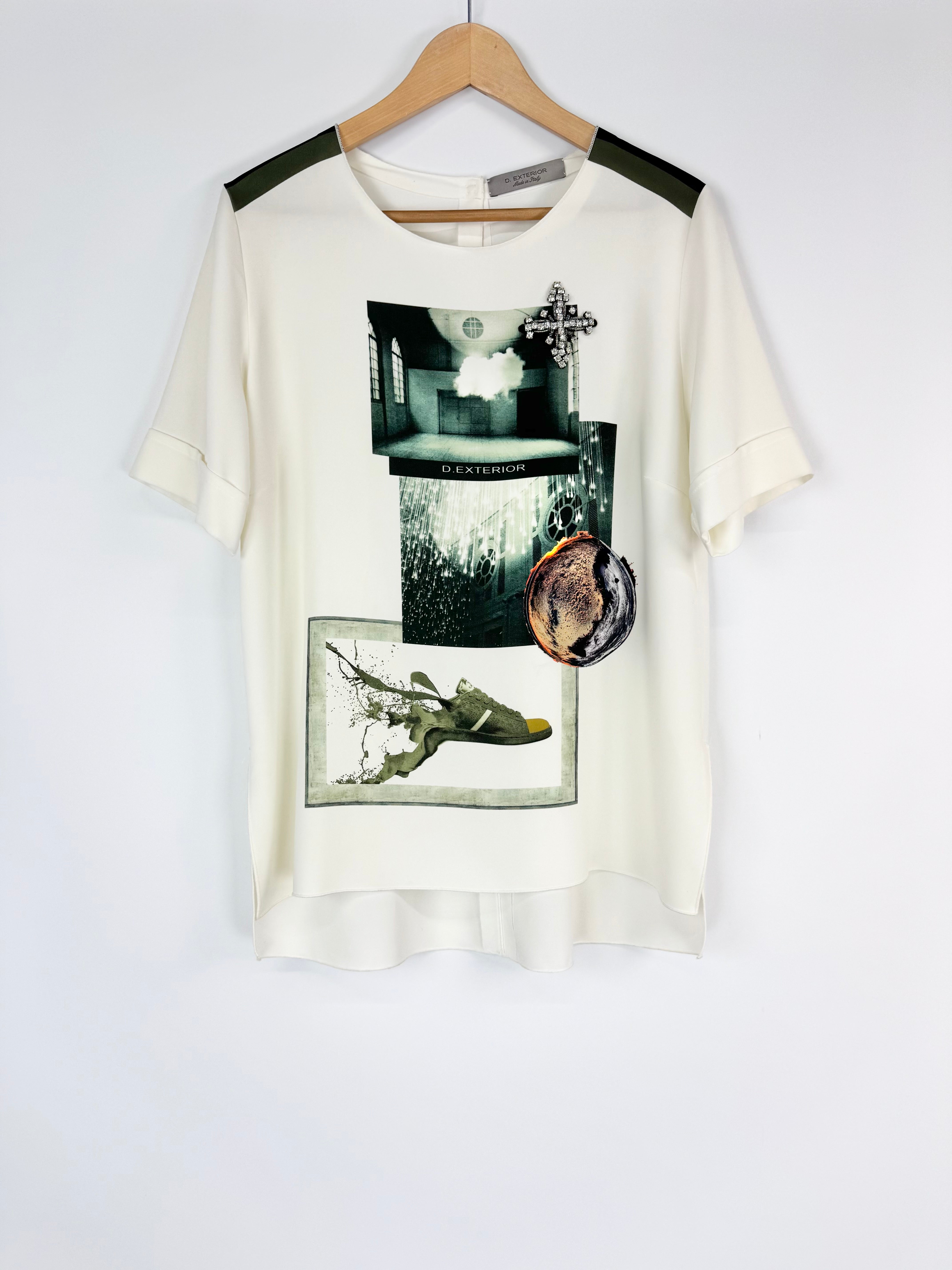 White t-shirt with graphic designs on a hanger against a white background