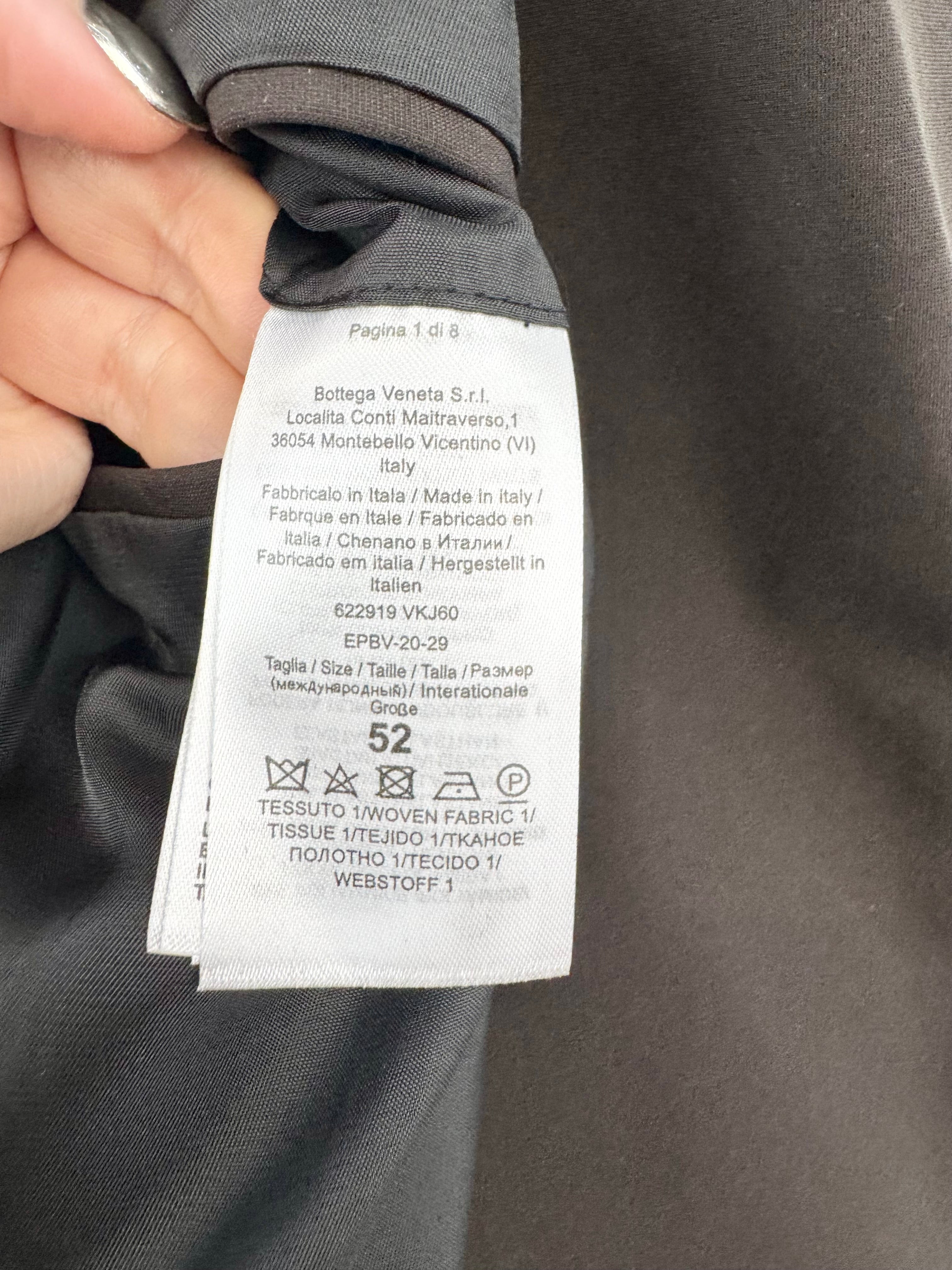 Close-up of a clothing label on a gray fabric background