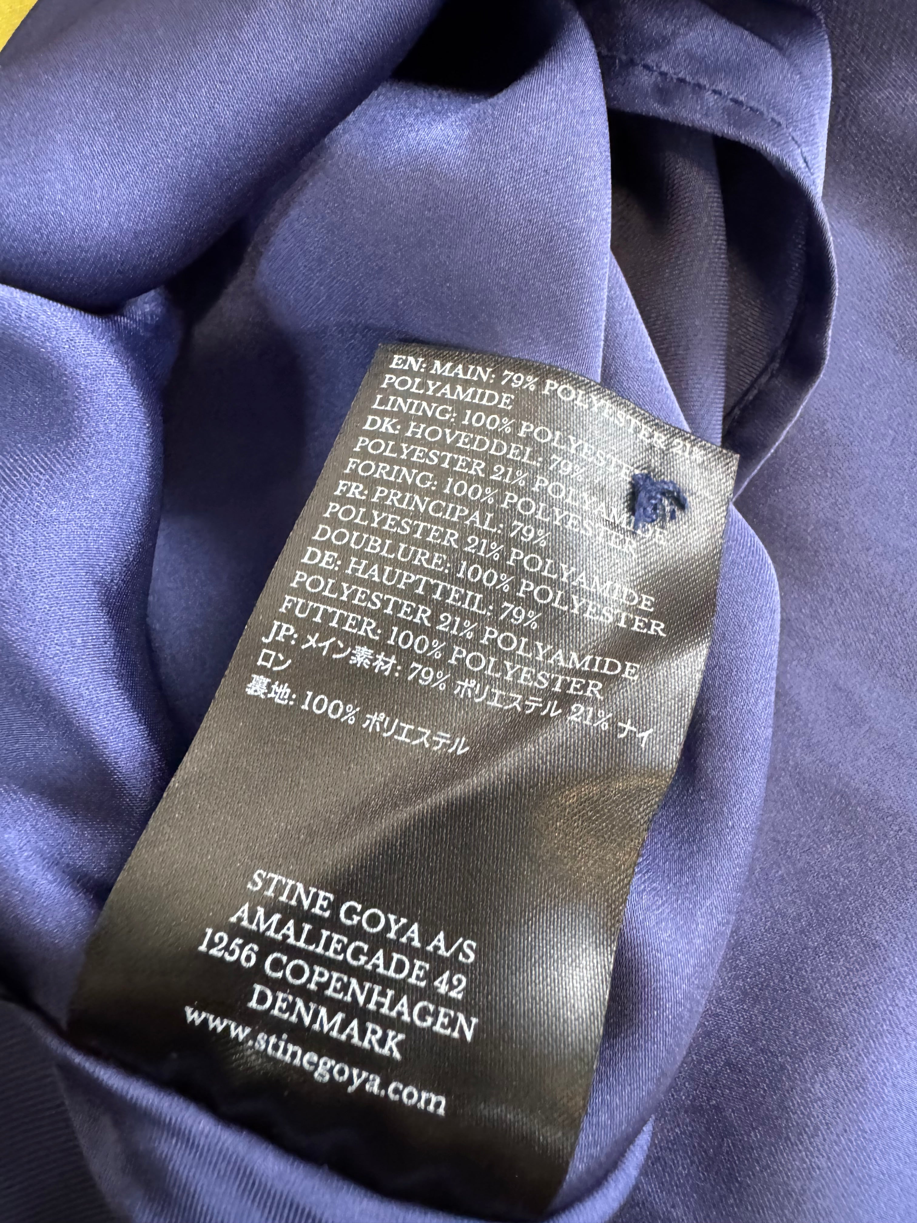 Clothing label on a purple fabric background