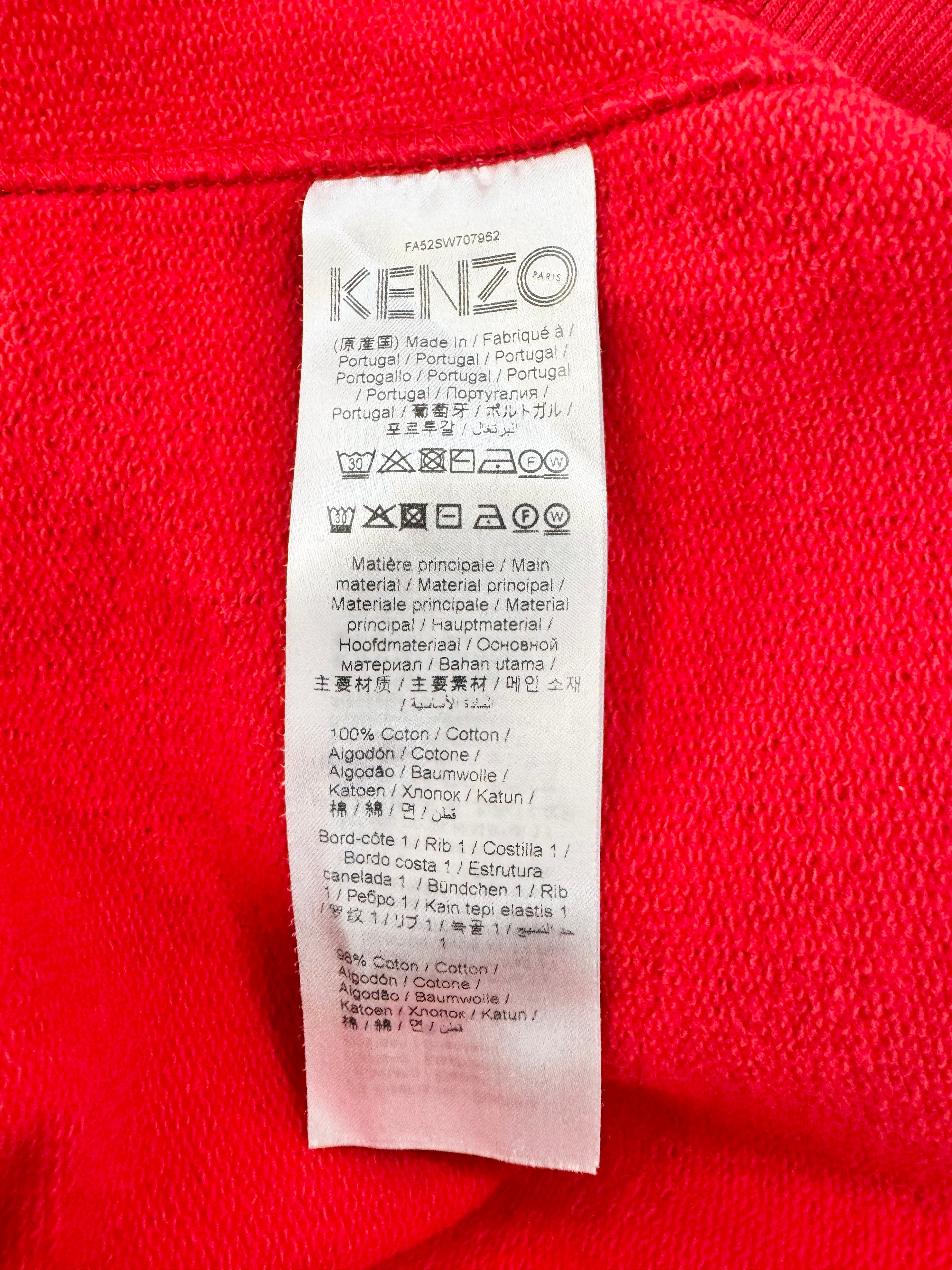 Kenzo label on a red garment with text and symbols.