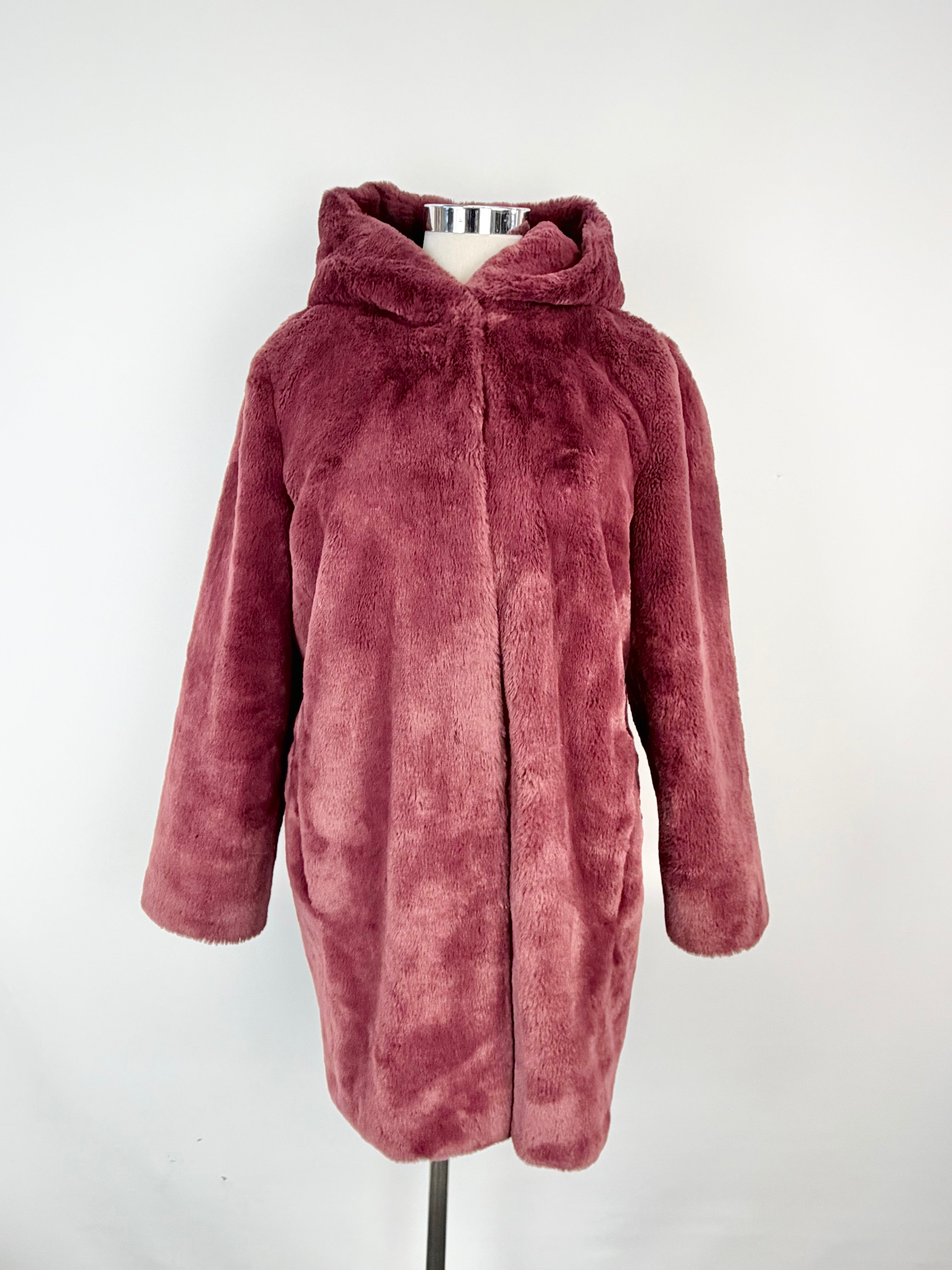Pink faux fur coat on a mannequin against a white background