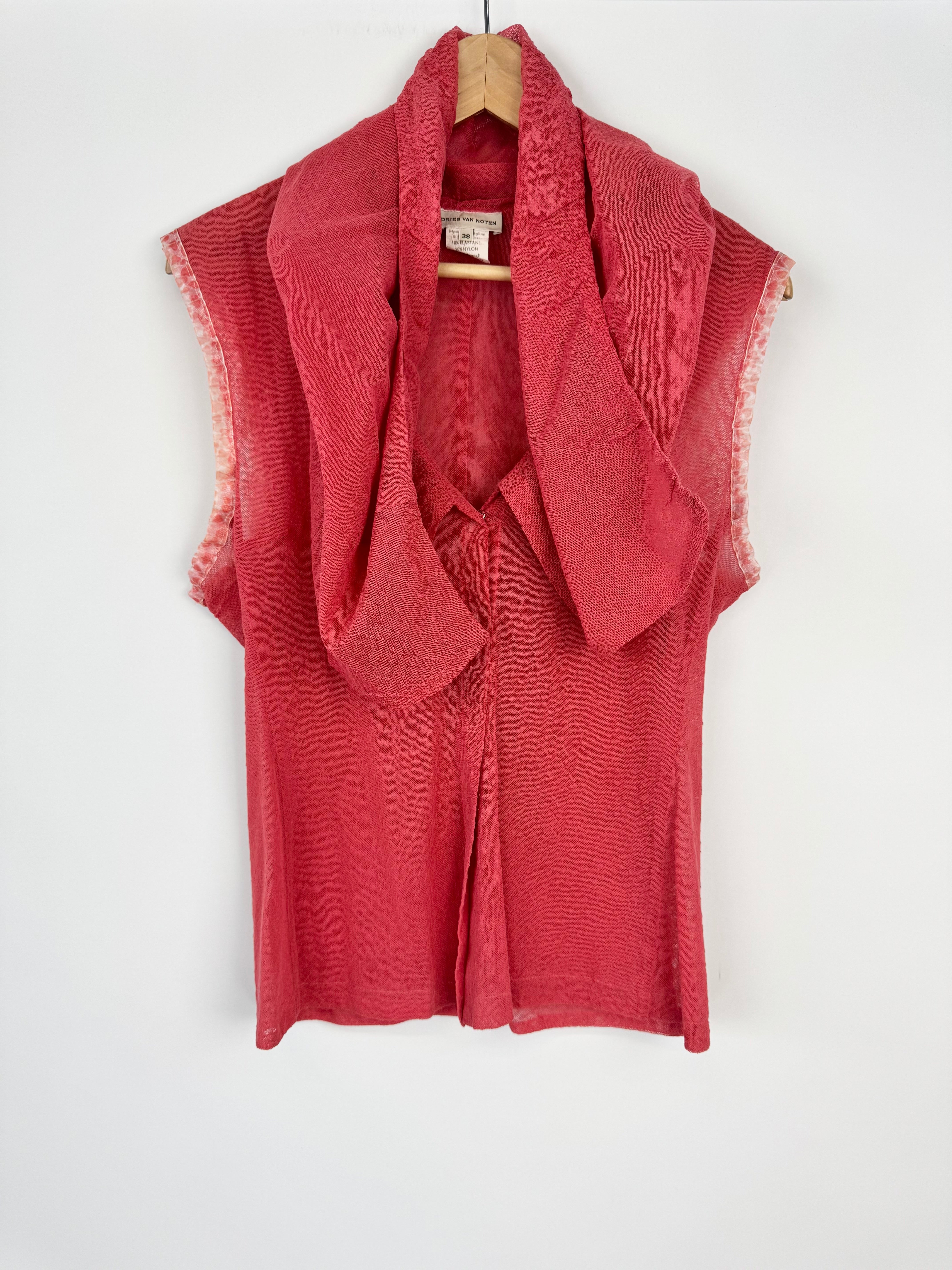 Red sleeveless top with sheer overlay on a white background