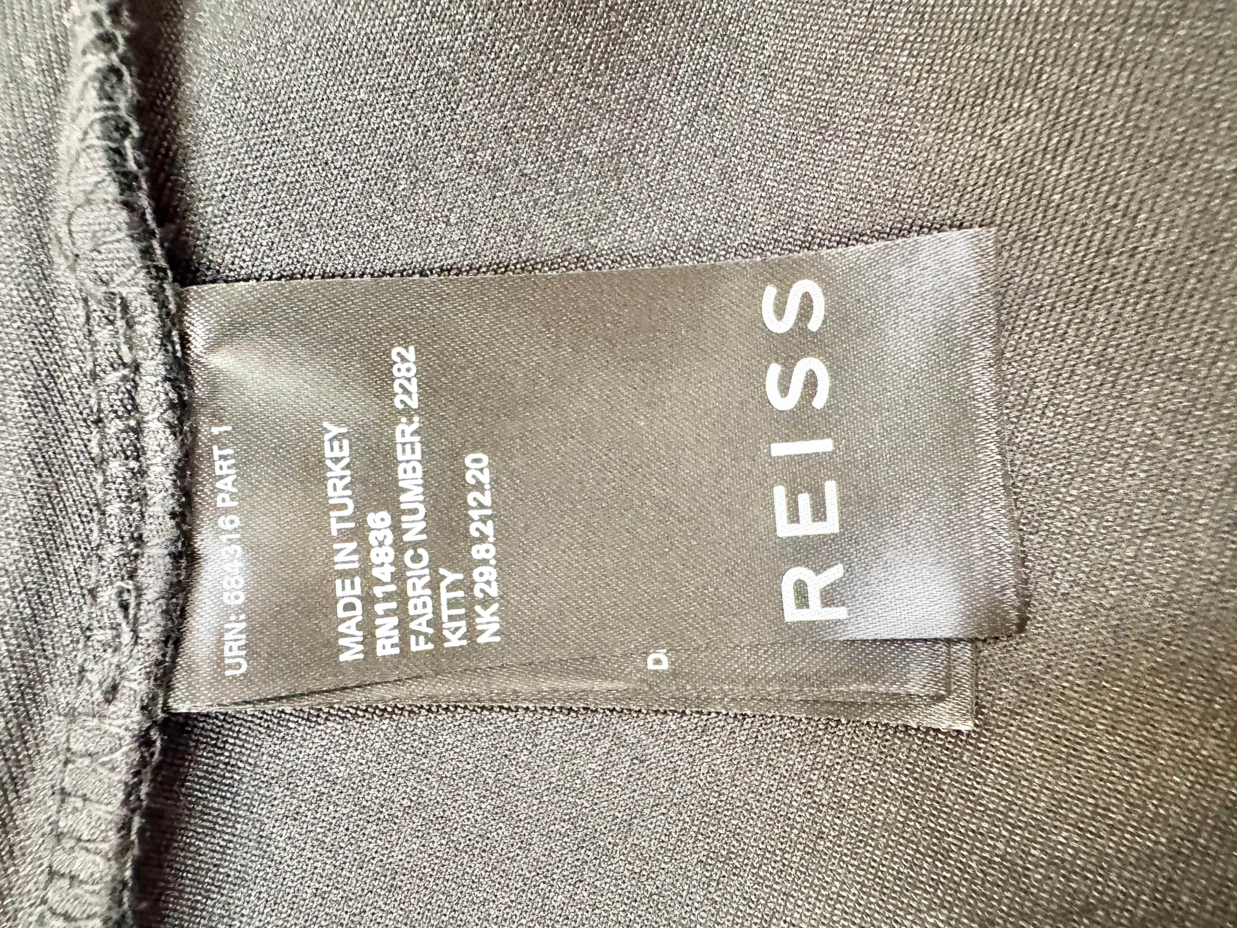 Close-up of a Reiss label on a fabric background