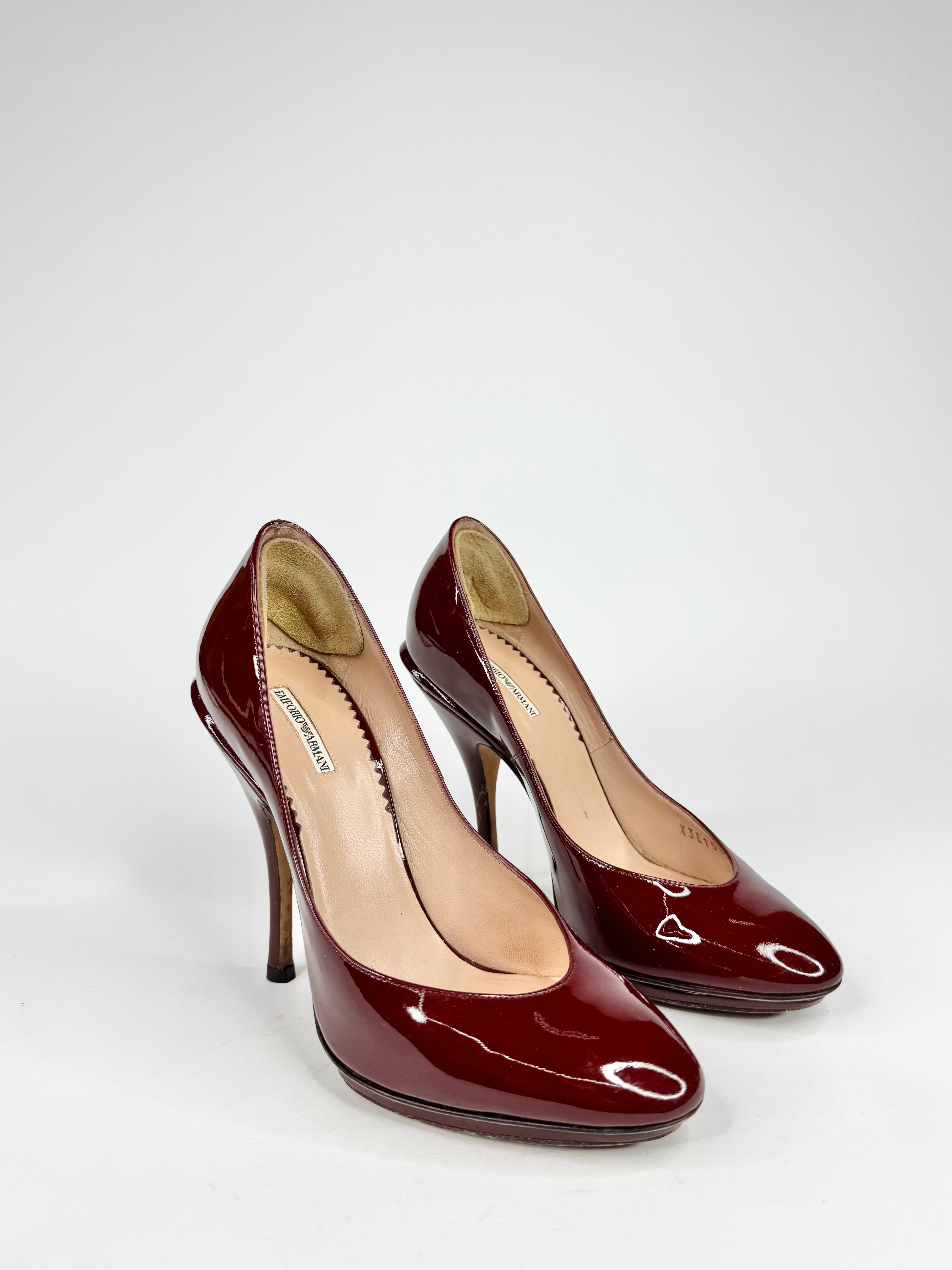 Pair of brown high-heeled shoes on a white background