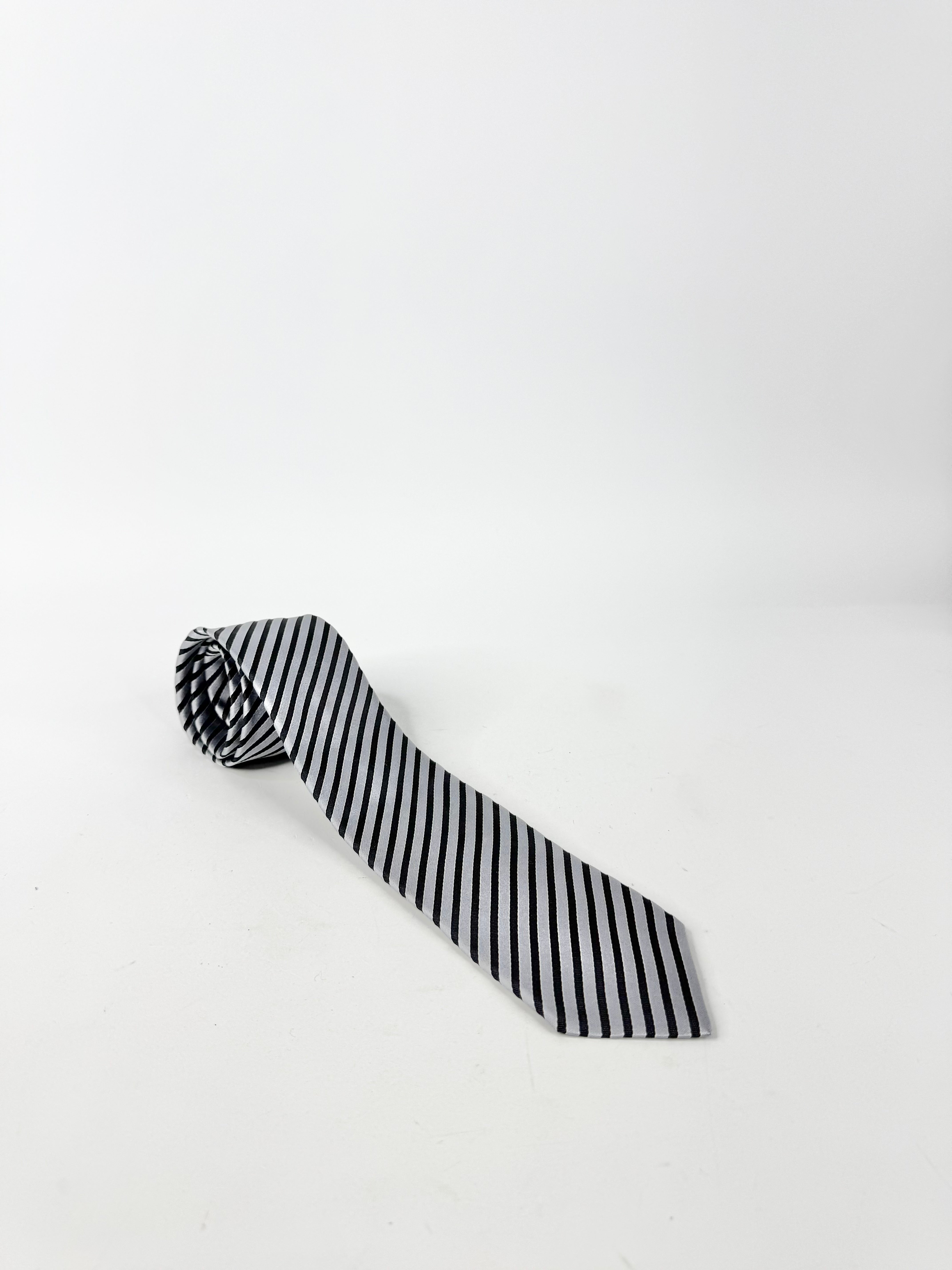 Black and white striped tie on a light gray background