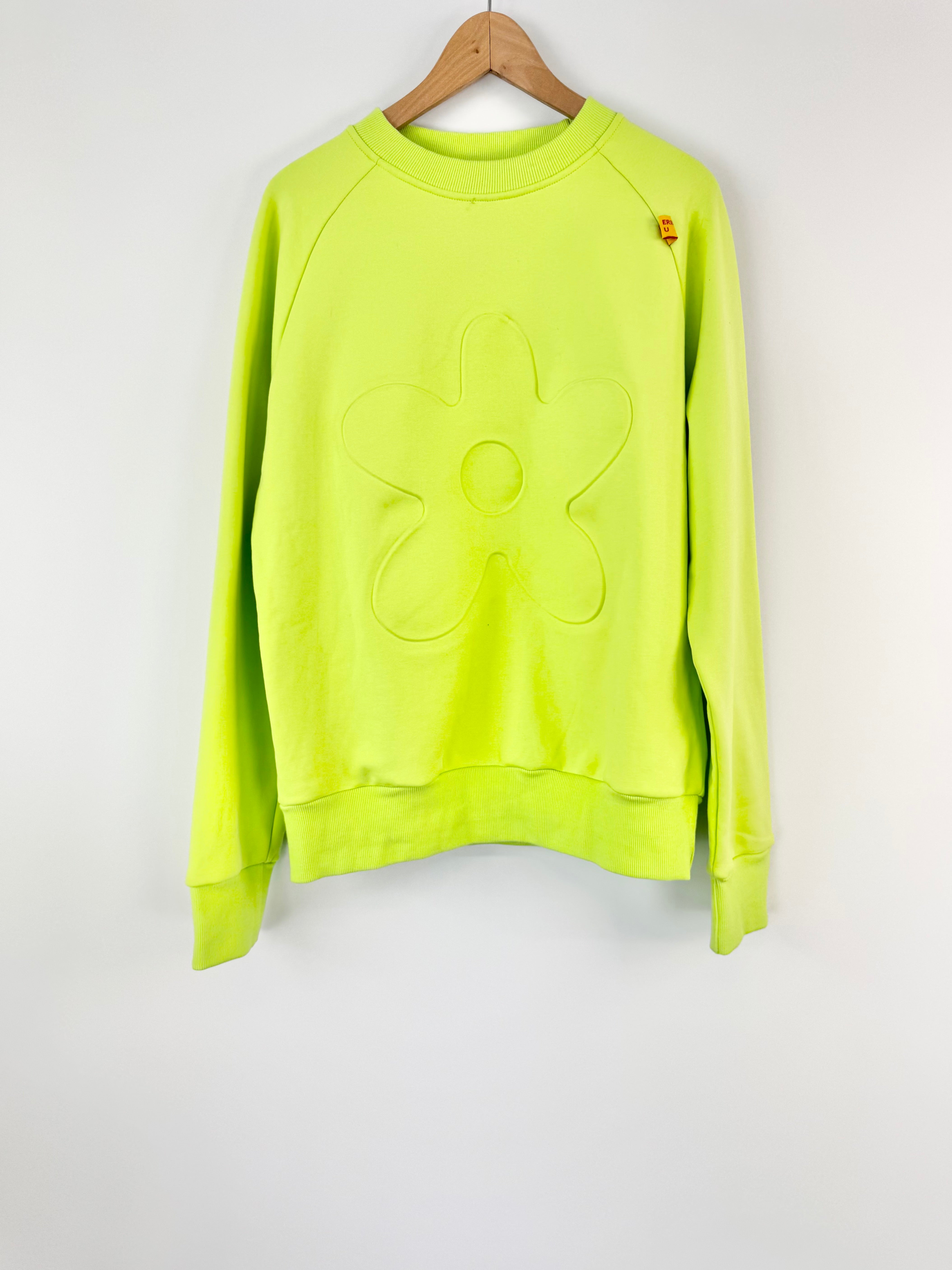 Neon green sweatshirt on a hanger against a white background