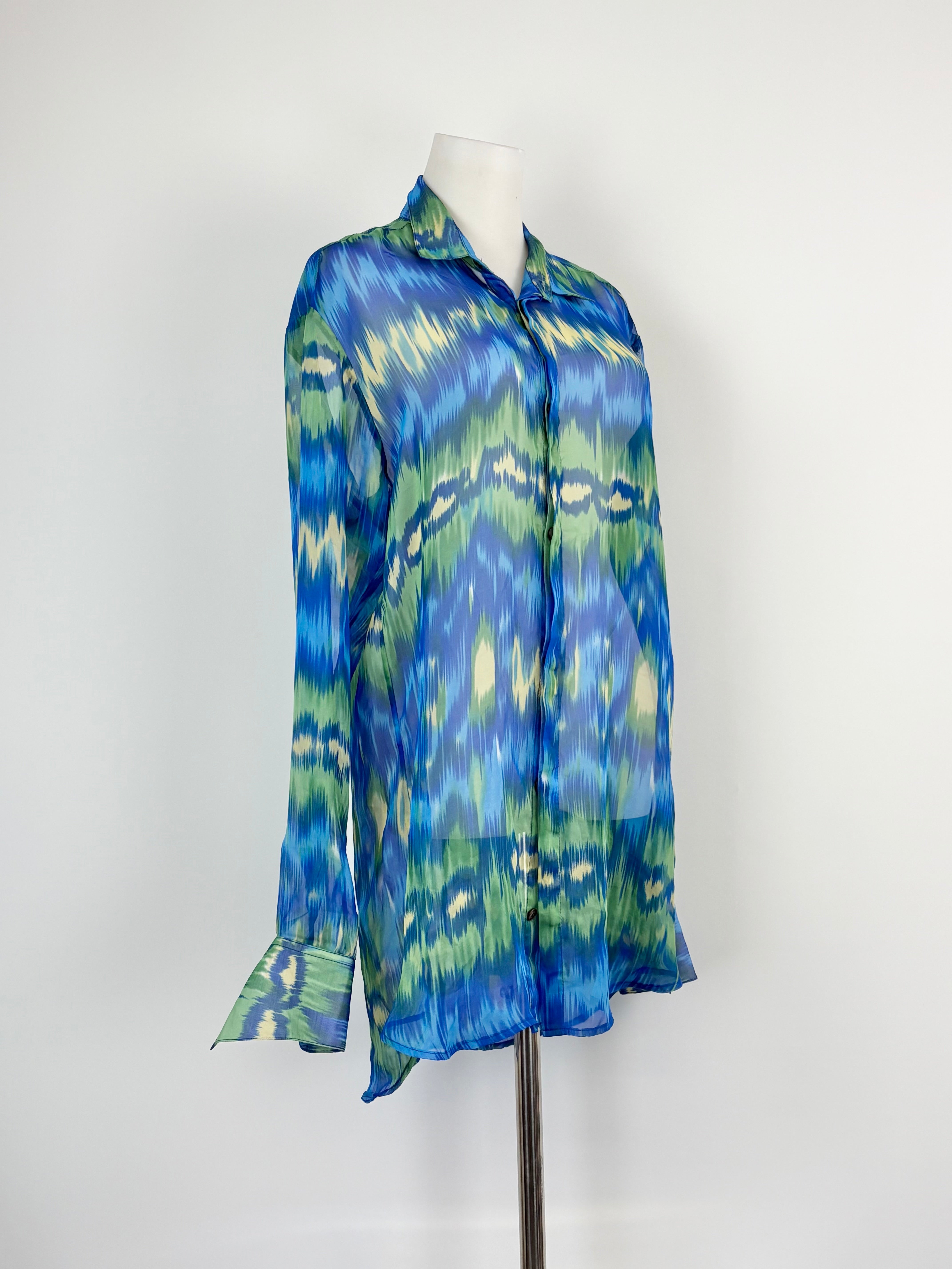 A blue and green sheer silk shirt on a mannequin, displaying the front view with the shirt's buttons and neckline visible.